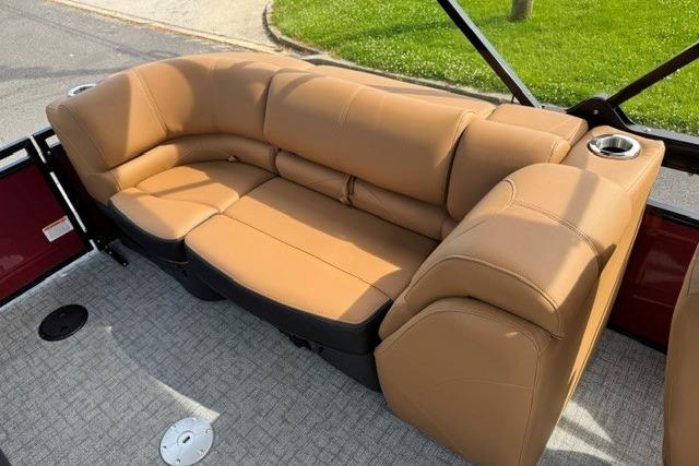 Luxurious tan seating on 2026 Regency 230 DL boat, featuring cup holders and plush design.