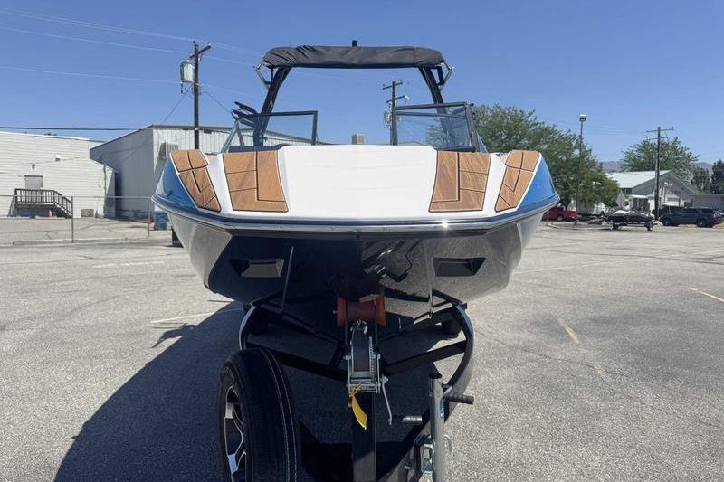 2023 Moomba Mojo Pro boat on trailer, front view in parking lot.