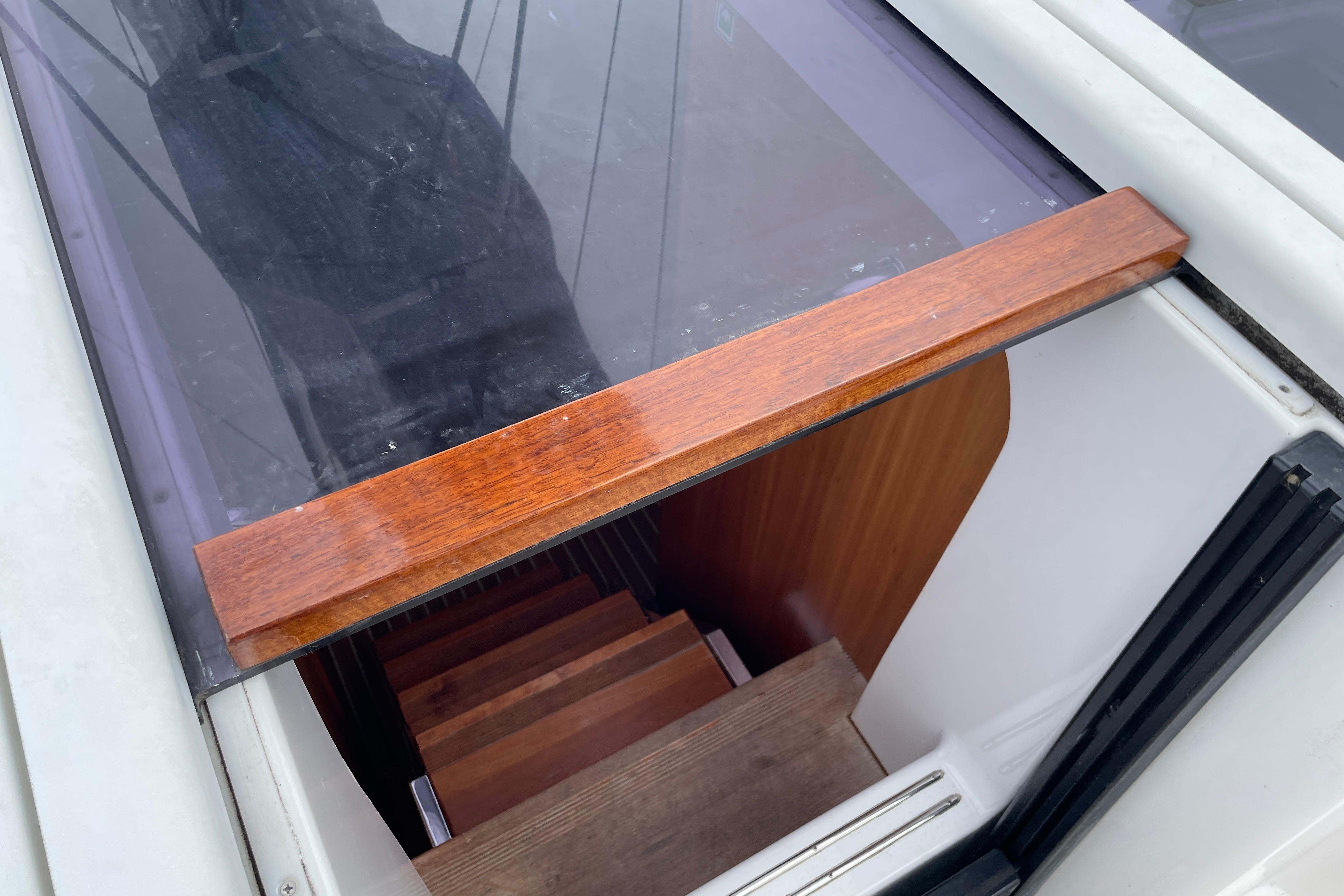Stairway entrance on a 2014 Hanse 415 sailboat, featuring wooden trim and steps.