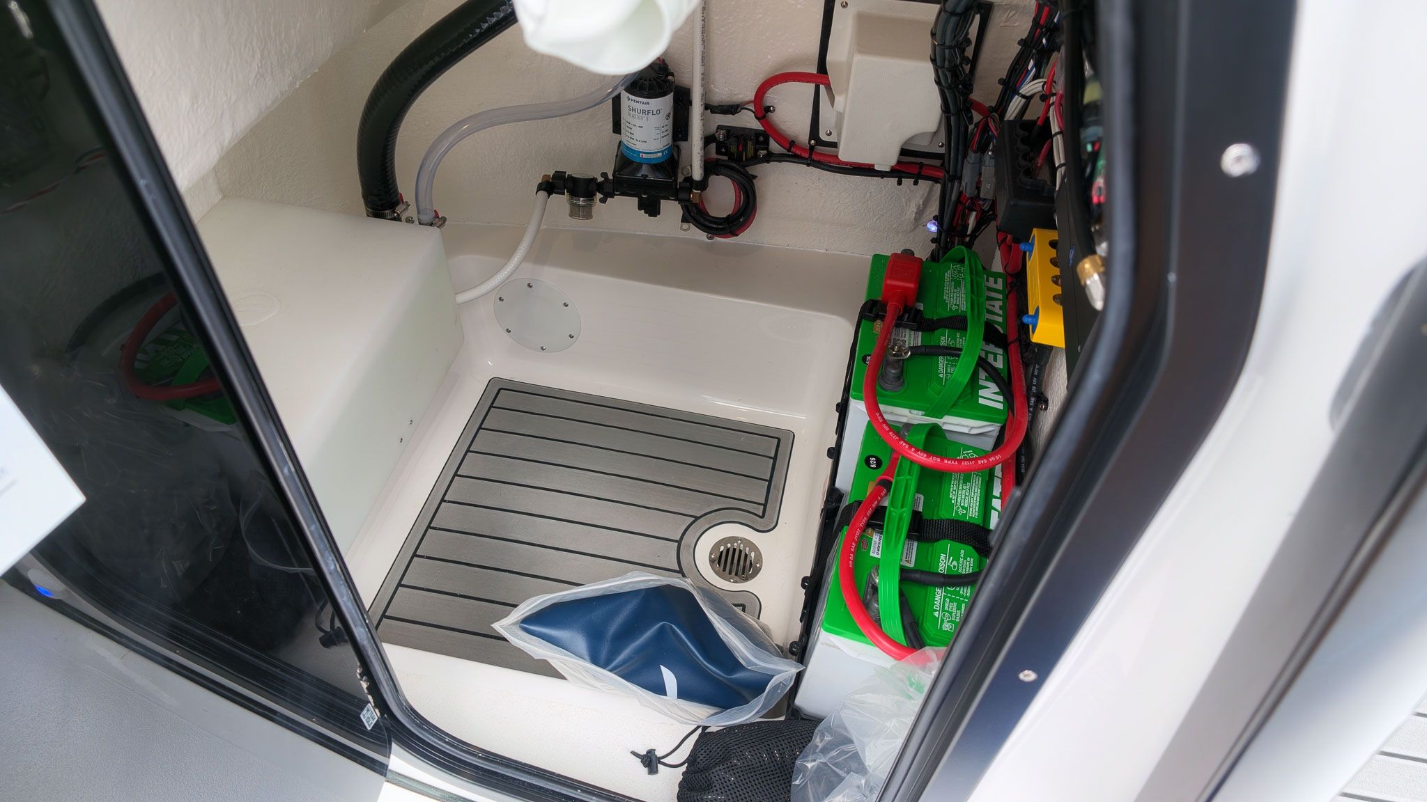 Interior of a boat with batteries and wiring.