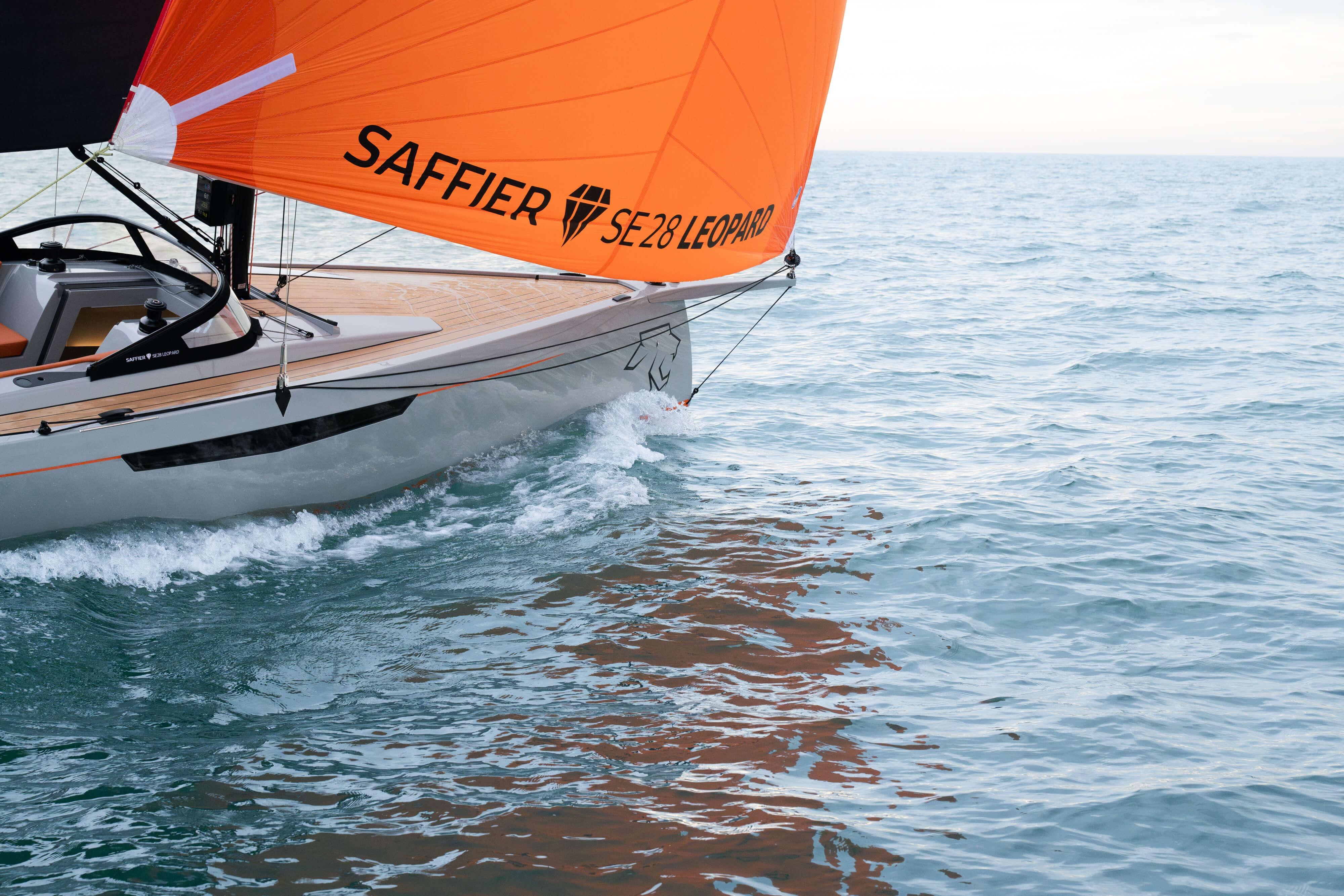 Saffier SE 28 Leopard 2026 sailboat with orange sail on open water.