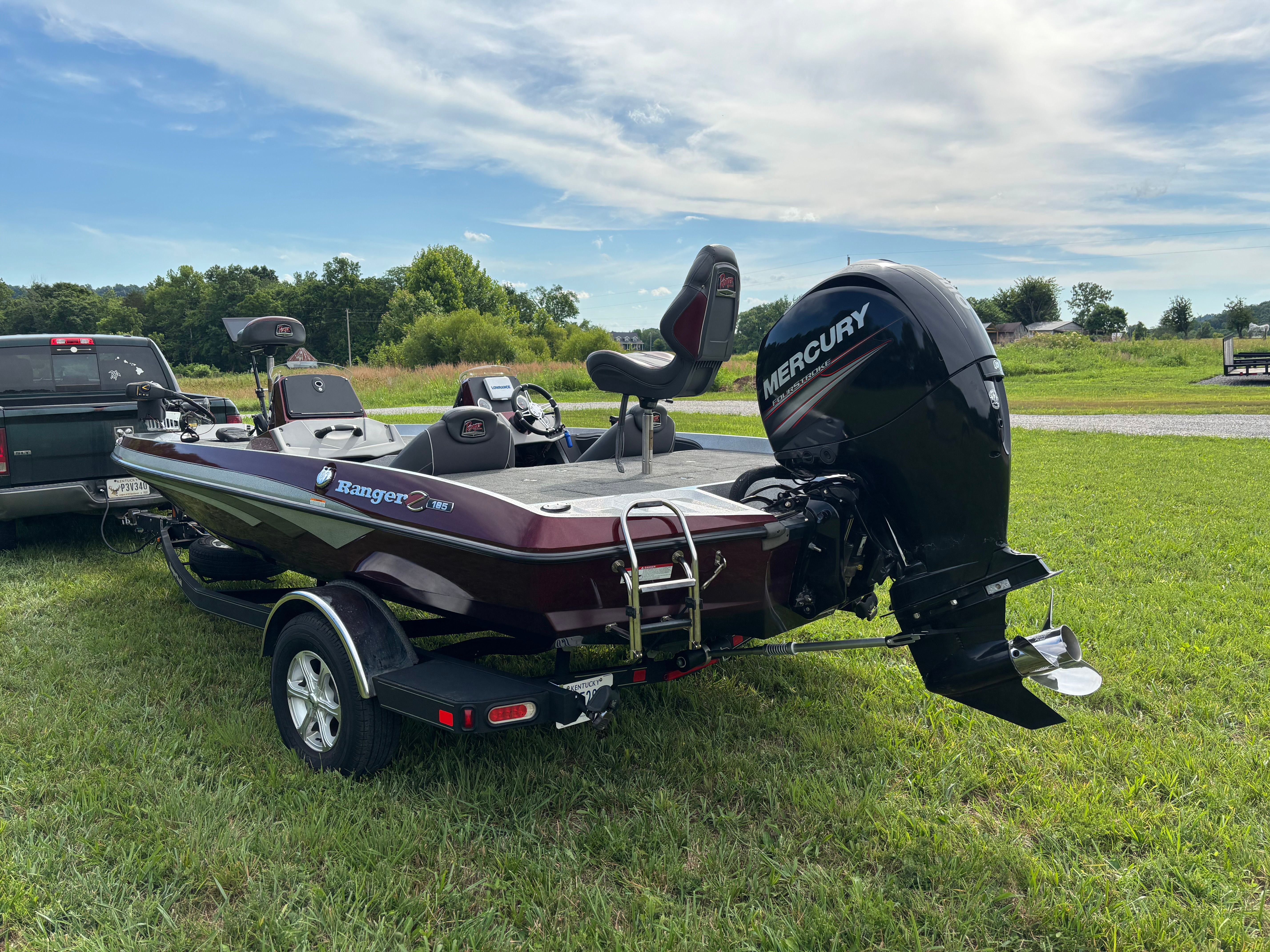 A 2016 Ranger Z 185 boat is on a trailer on a grassy field.