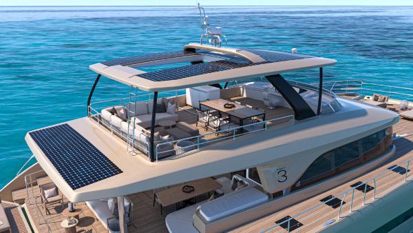 Luxurious 2025 Lagoon 83 yacht with solar panels, cruising on clear blue ocean waters.