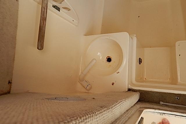2003 World Cat 270 EC interior sink area with beige carpeting and white fixtures.