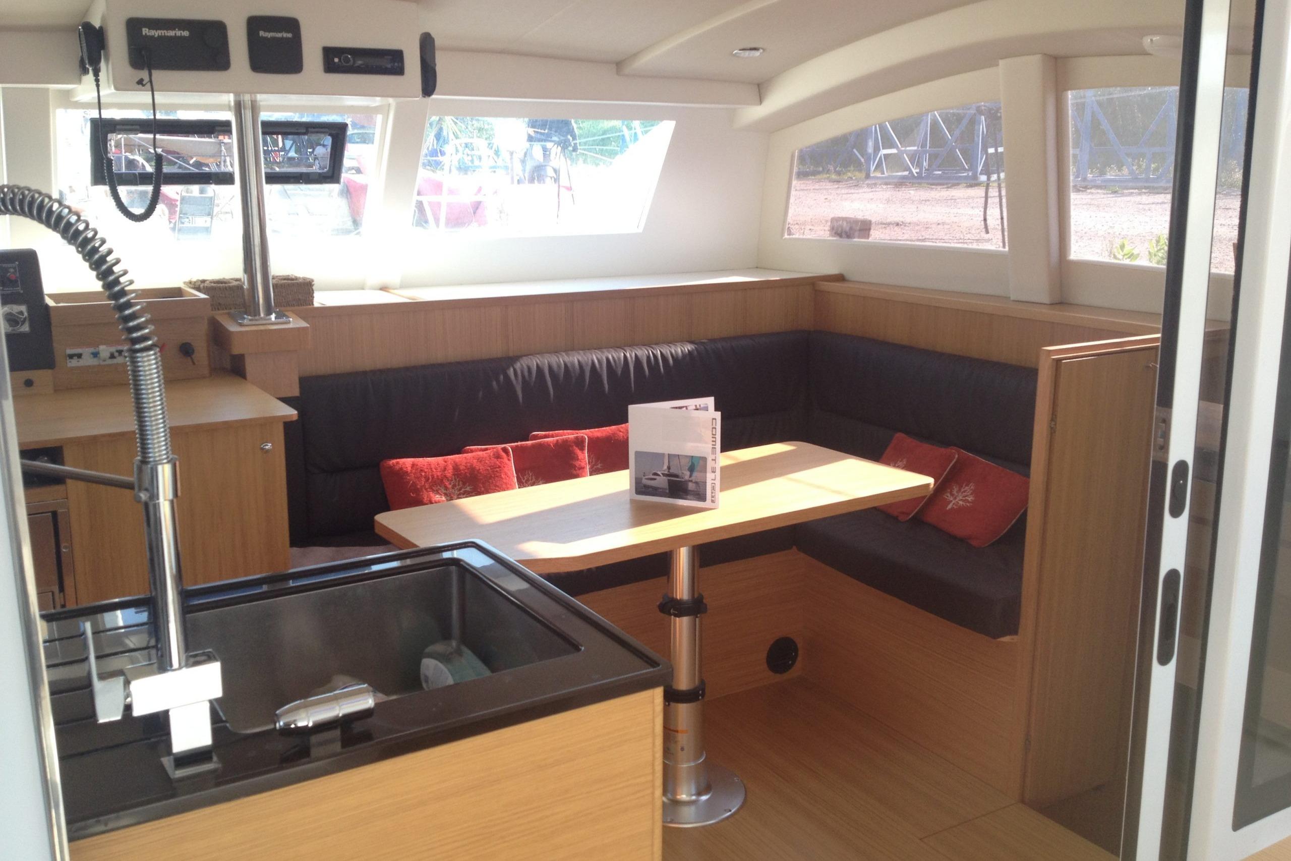 Modern interior of 2026 C-Catamarans C-CAT 38 with cozy seating and dining area.