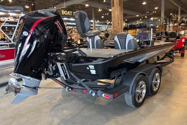 2025 Ranger ALPHA 208 boat with powerful outboard motor in showroom setting.