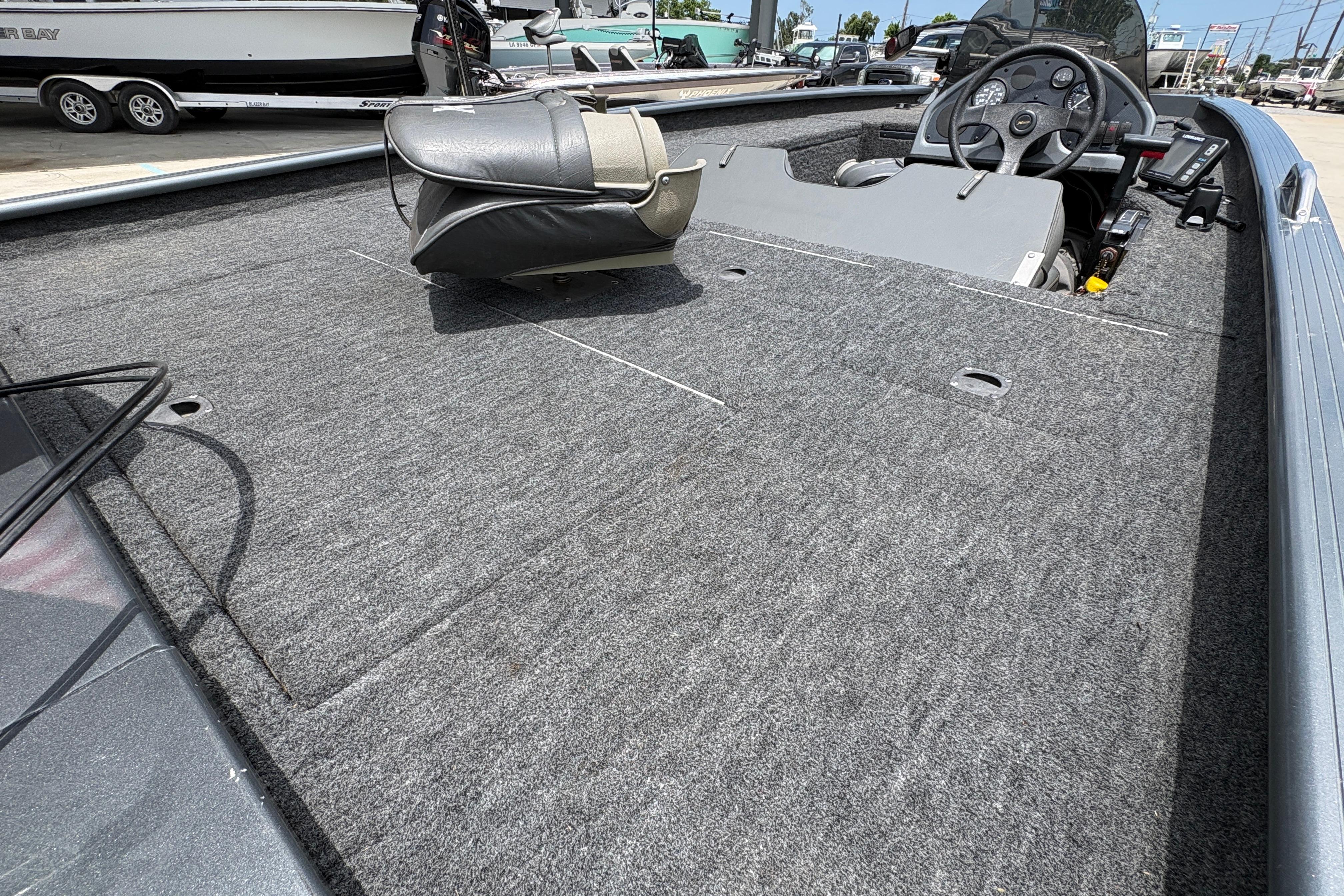 2000 Xpress X18 boat interior with steering wheel and carpeted deck.