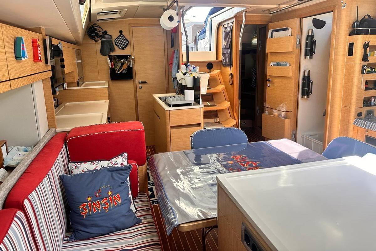 Interior of 2018 Hanse 548 yacht with modern kitchen and cozy seating area.