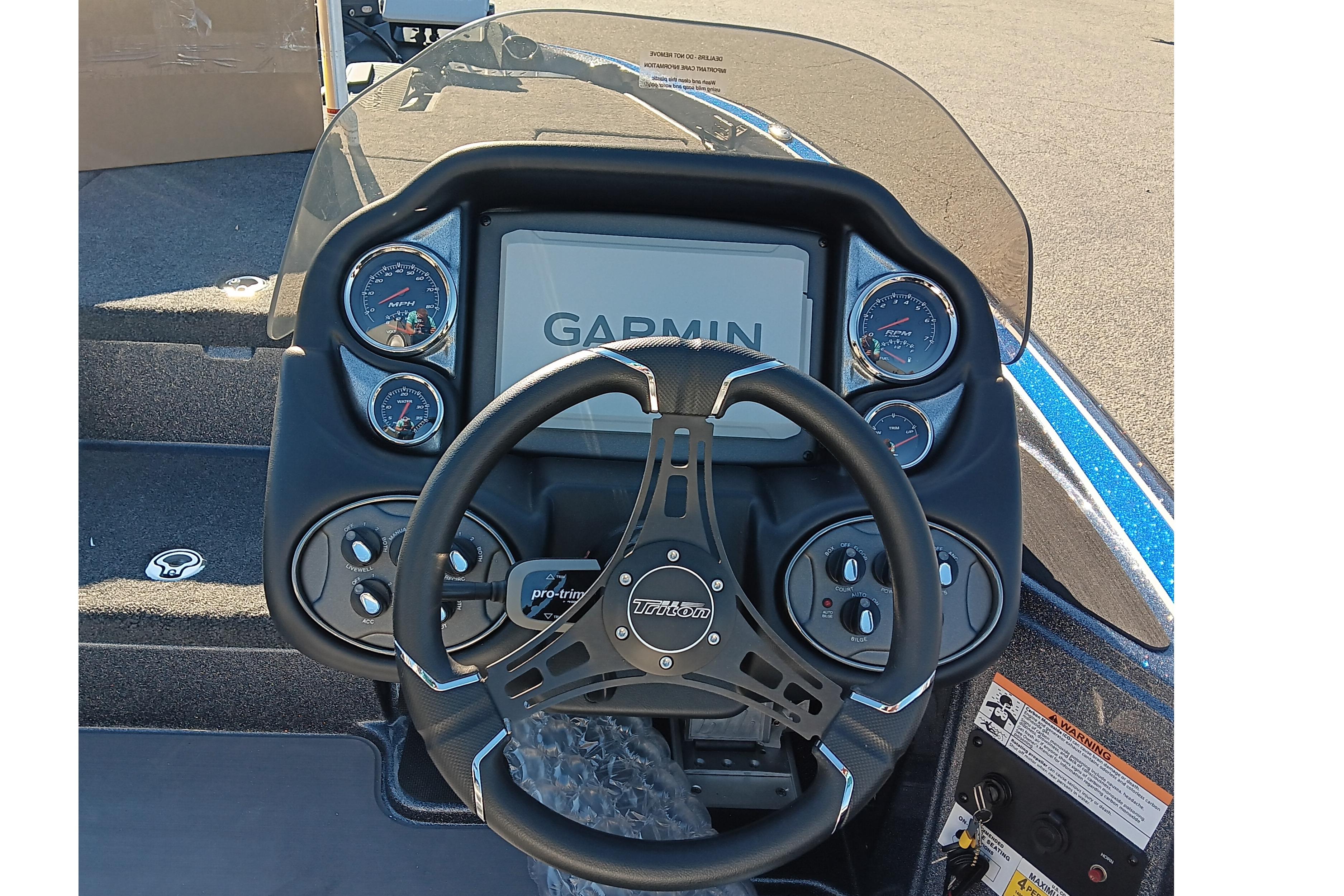 2026 Triton 18 TrX boat dashboard with Garmin display and steering wheel.