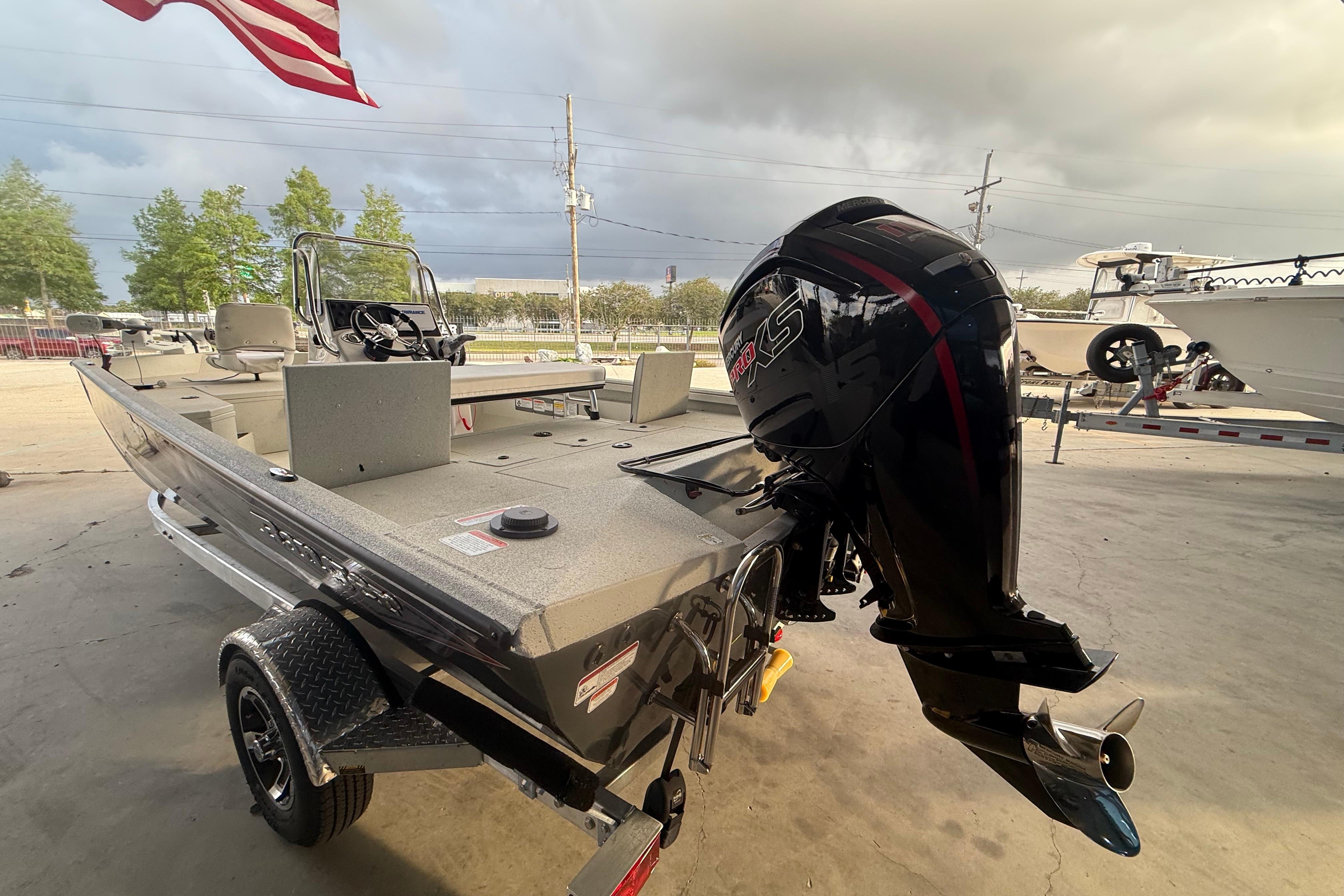 2026 Ranger RB190 boat with powerful outboard motor, parked under cloudy sky.