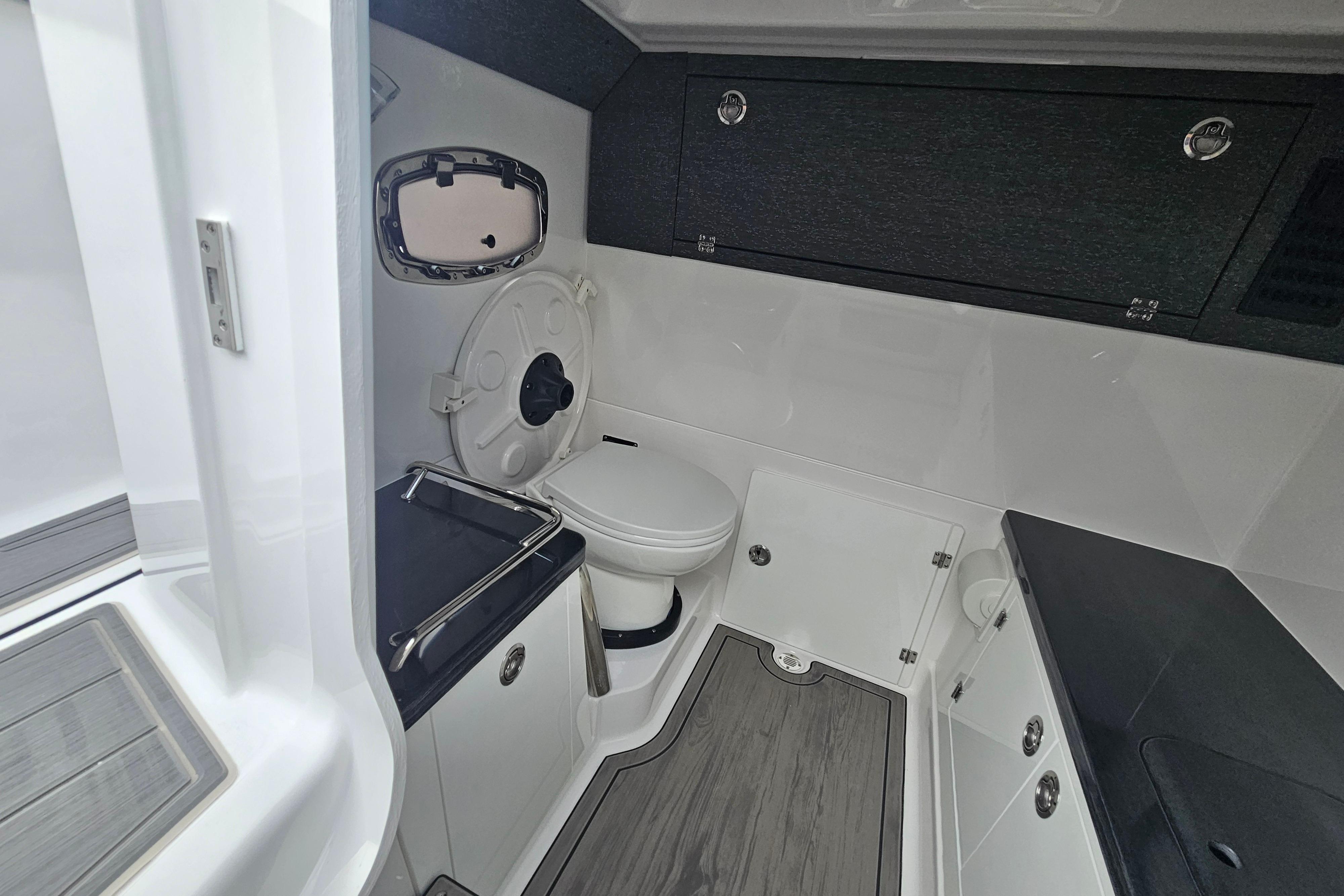 Modern bathroom interior of 2026 Monterey Elite 27 OB boat, featuring sleek design and amenities.