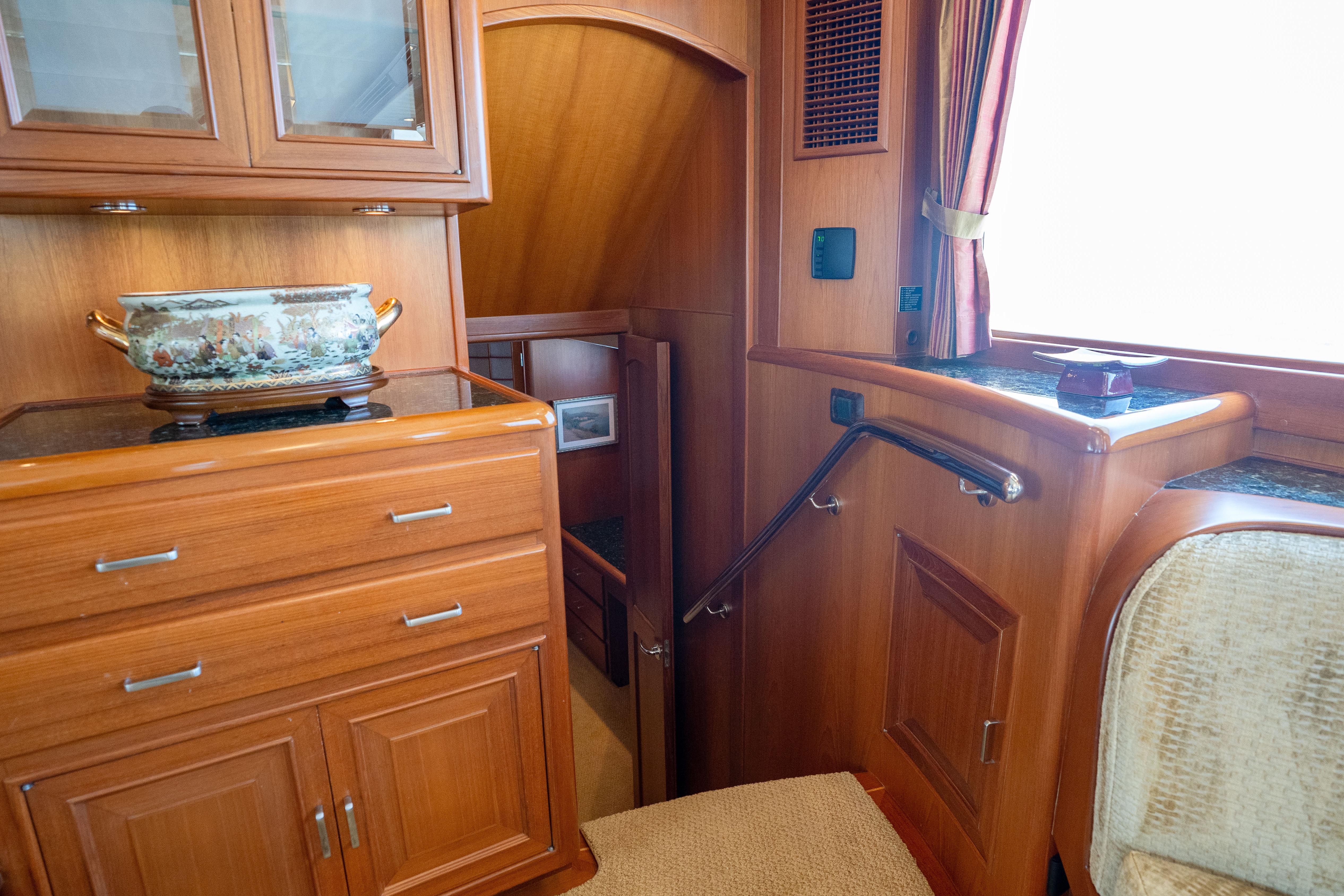 Luxurious wooden interior of a 2006 Fleming 75 yacht with elegant cabinetry and decor.