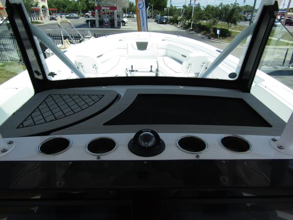 2024 Wellcraft 352 Fisherman boat dashboard with cup holders and navigation equipment.