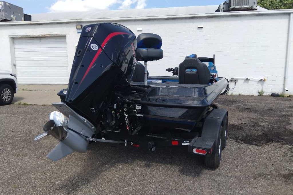 2026 Nitro Z19 XL Pro boat with powerful outboard motor in parking lot.