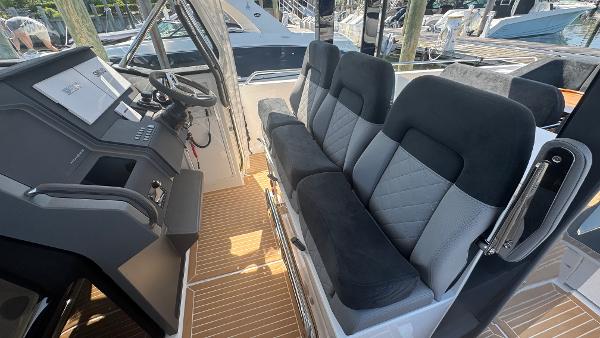 Interior of 2025 Nimbus T11 boat with modern seating and control panel.