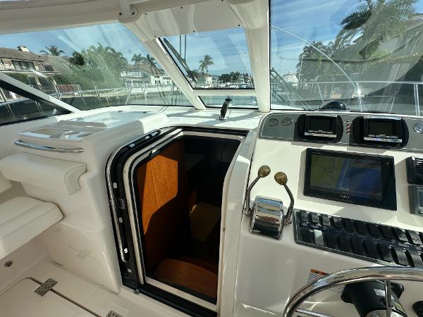 2006 Tiara Yachts 3200 Open helm with navigation equipment and cabin entrance.