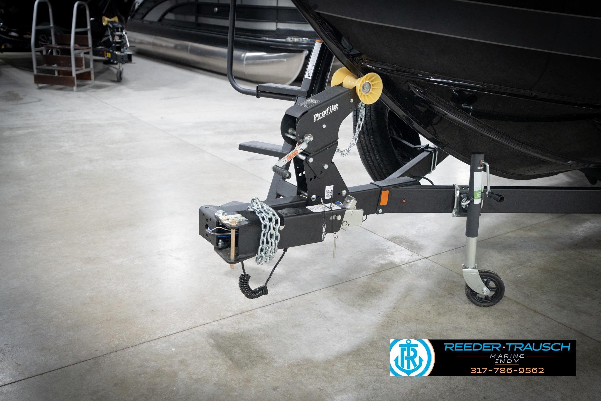 Trailer hitch of 2026 Lund 2275 Baron boat in showroom setting.