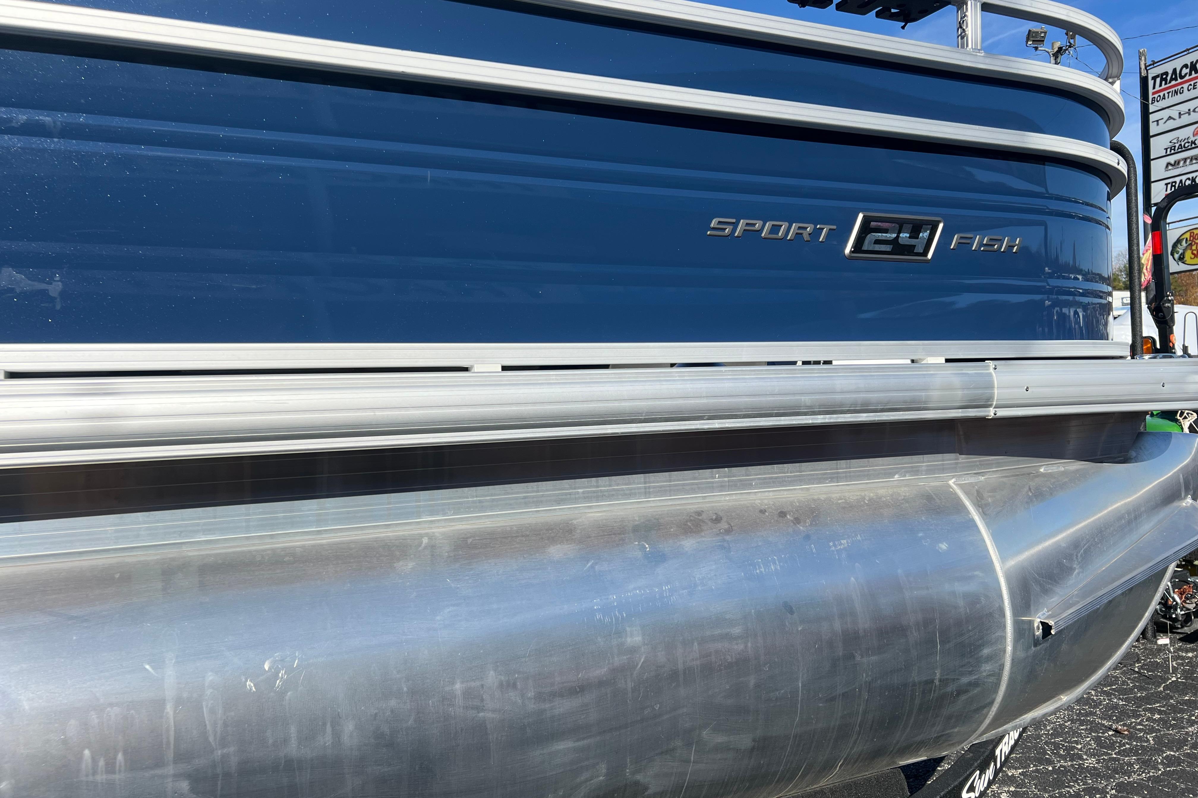 2026 Sun Tracker Sportfish 24 XP3 pontoon boat, blue and silver exterior.