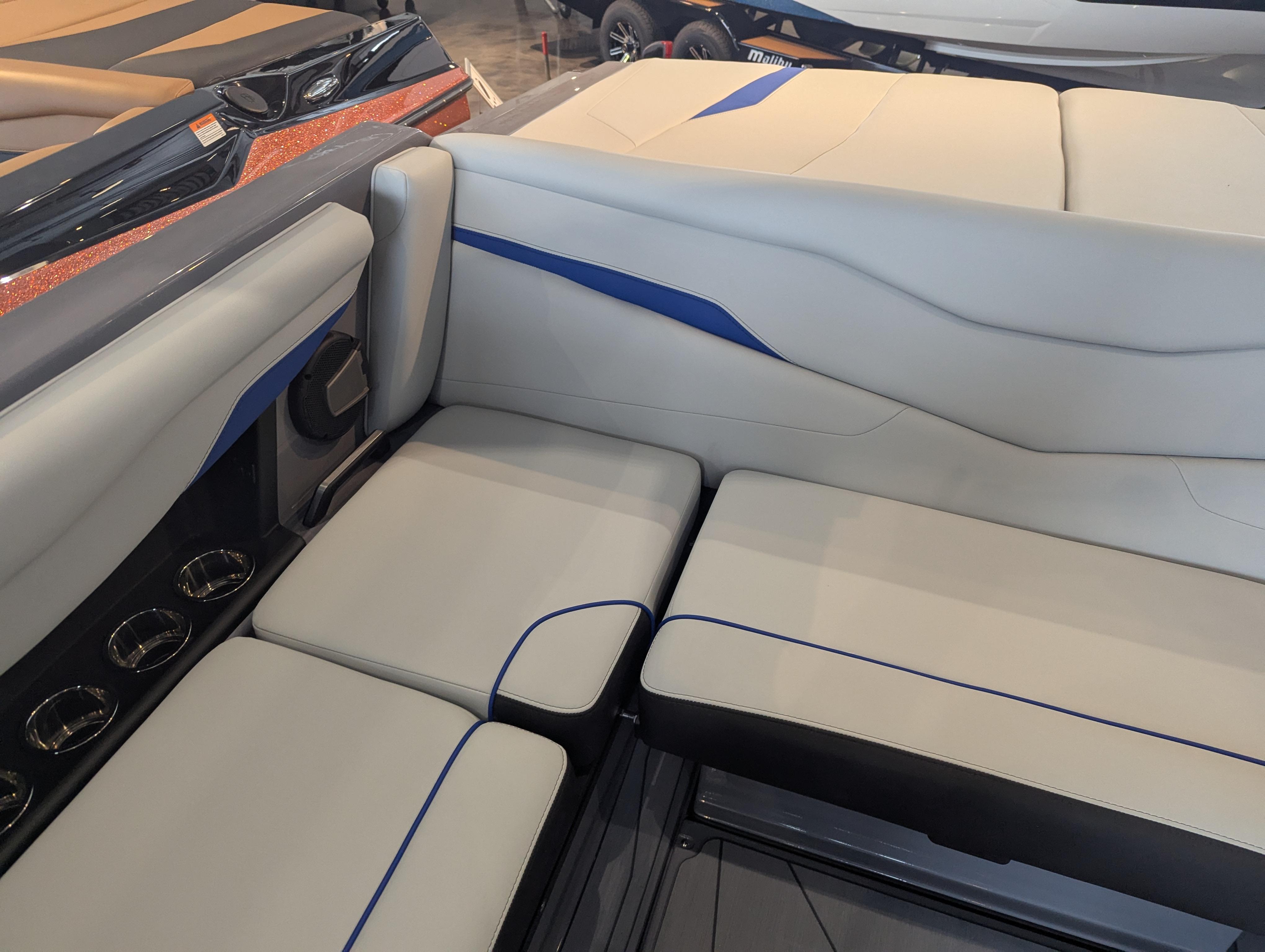 2025 Axis T220 boat interior with sleek gray and blue seating design.