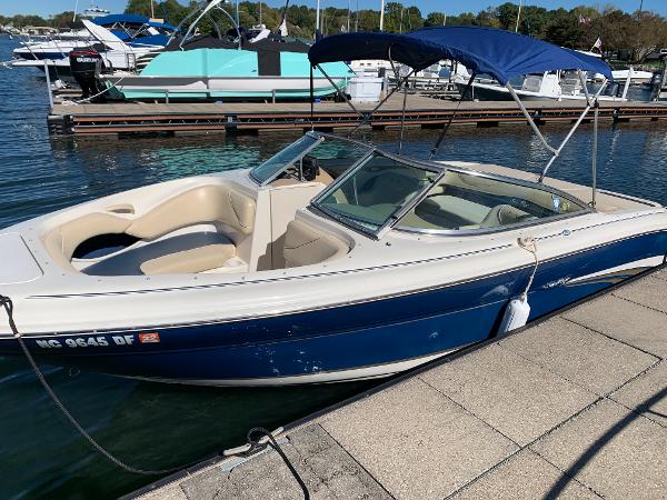 2000 Sea Ray 210 Bow Rider boat docked at a marina.