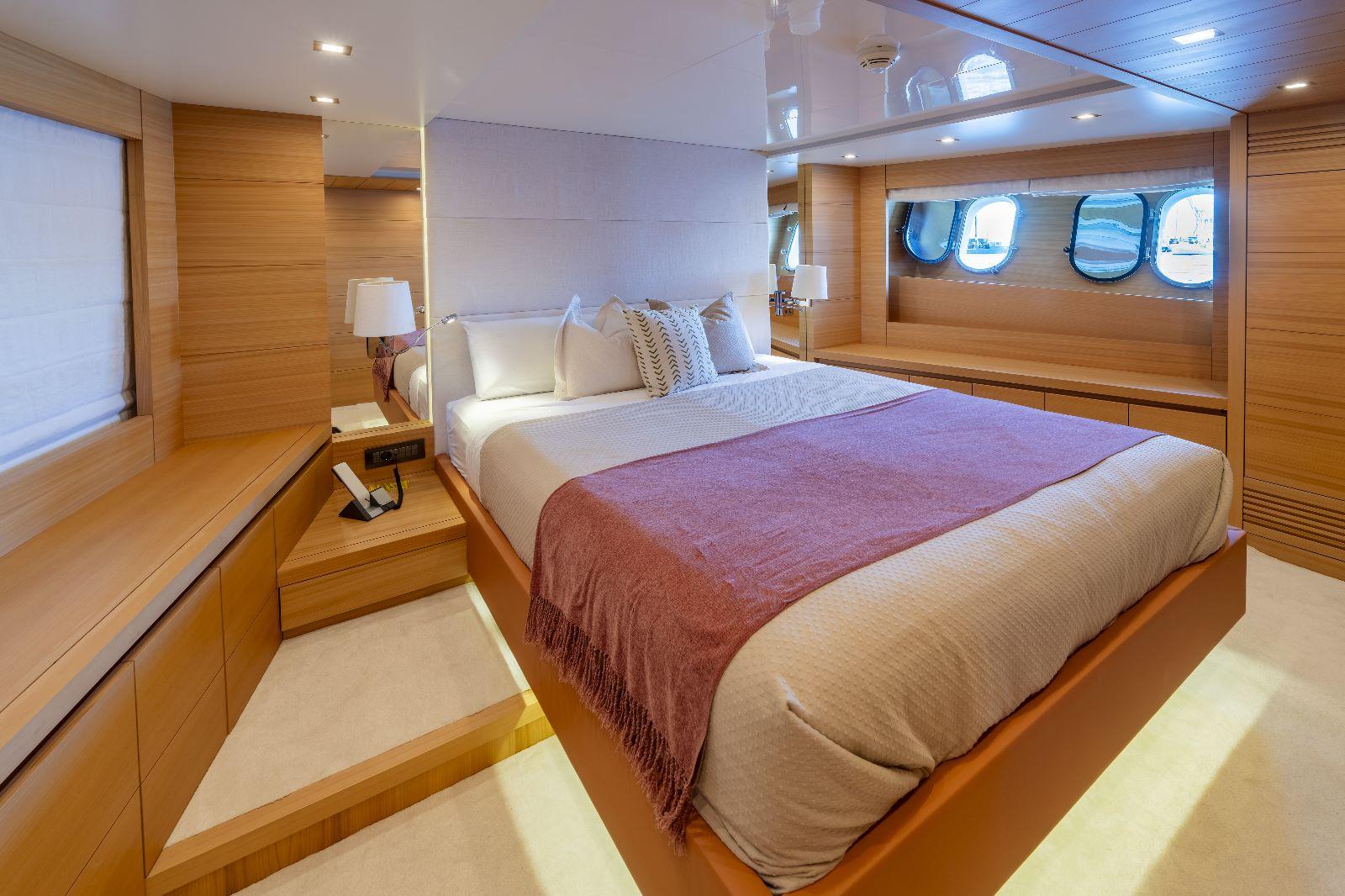 Luxurious bedroom interior on 2011 Maiora 27 yacht with modern design and cozy ambiance.