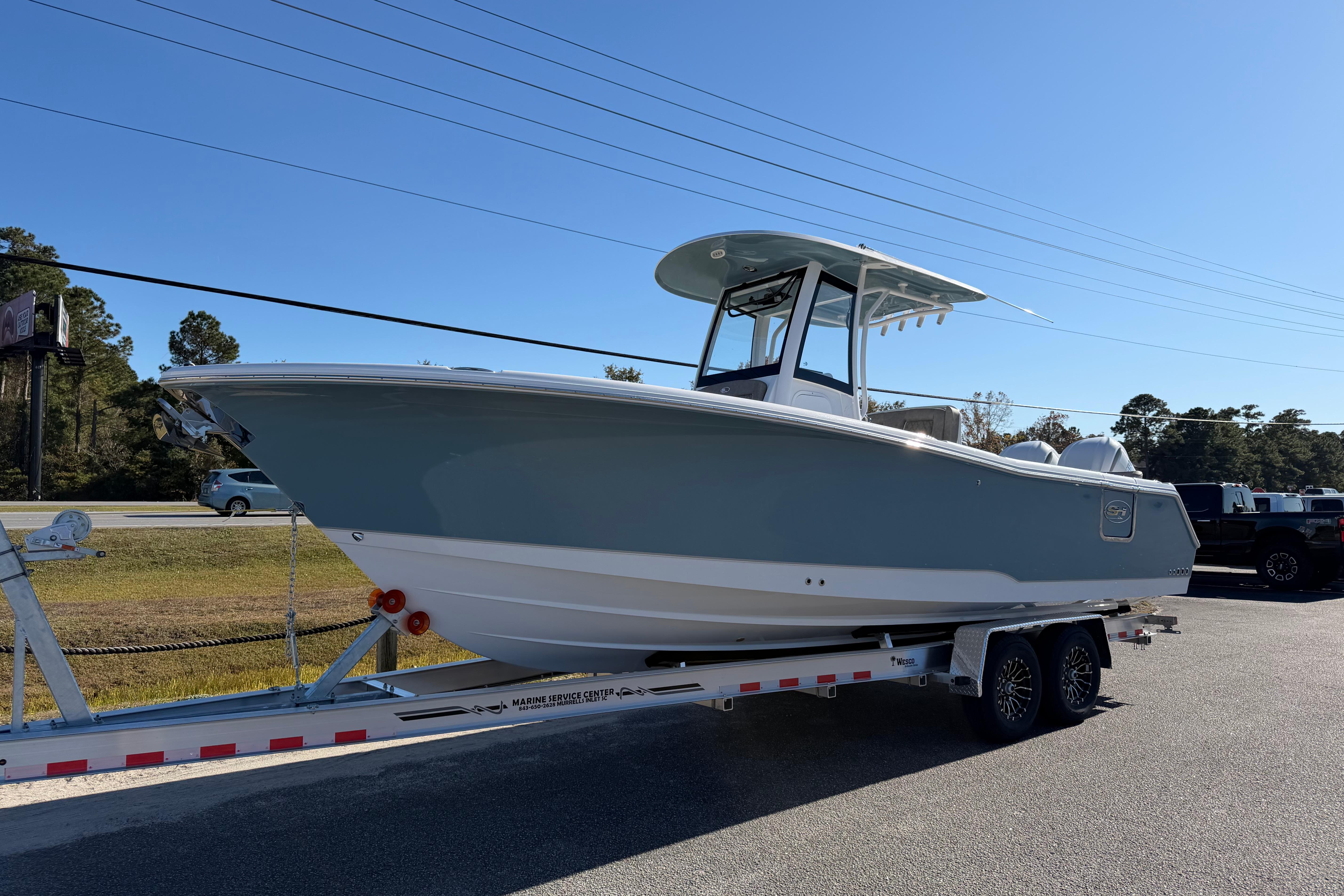 2026 Sea Hunt Ultra 275 Coffin Box boat on trailer, parked outdoors.