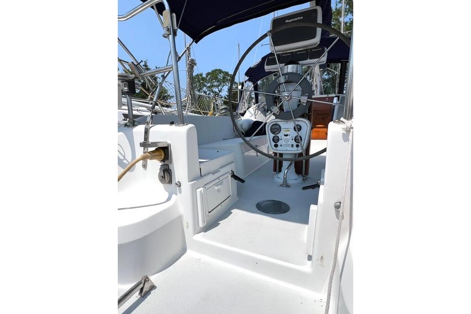 1999 Catalina 34 MkII sailboat cockpit with steering wheel and navigation equipment.