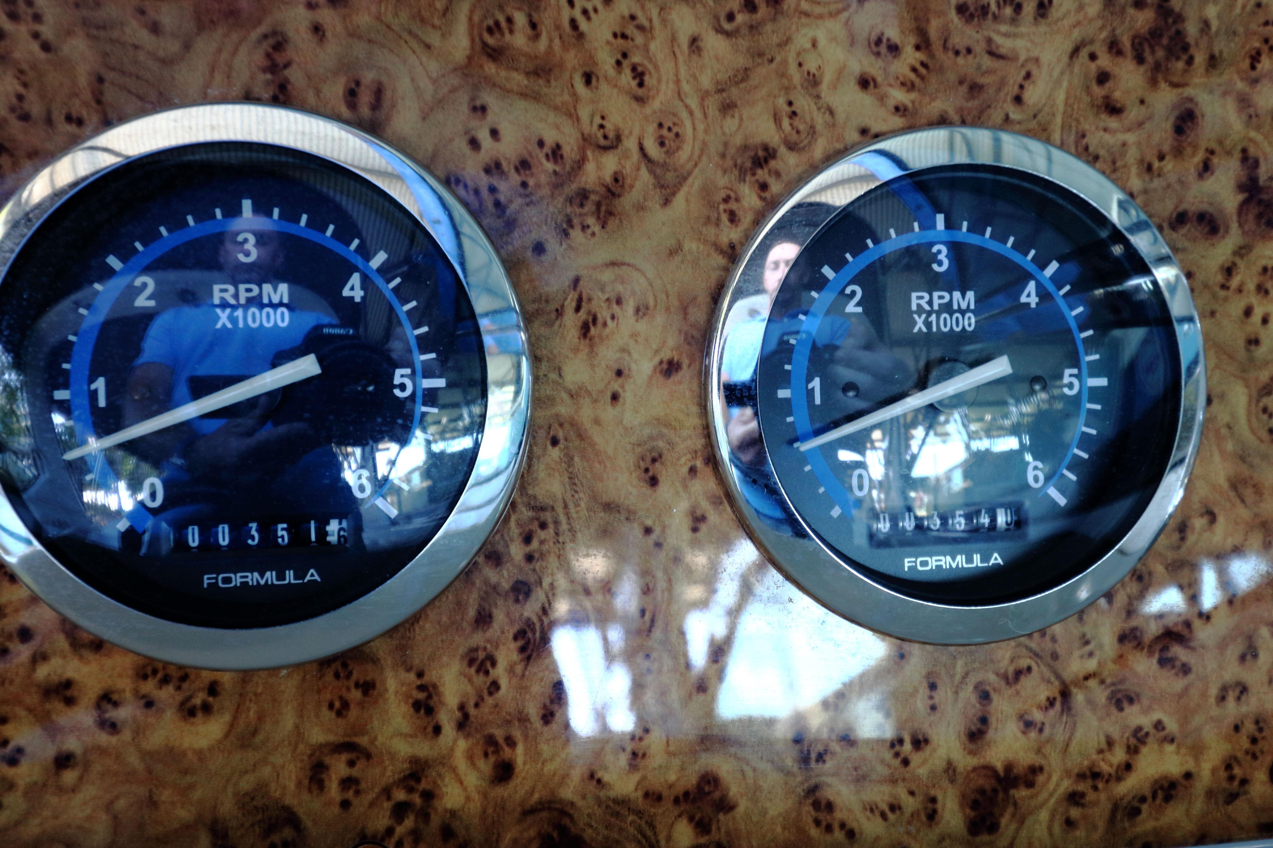 Close-up of RPM gauges on a 2006 Formula 330 Sun Sport boat dashboard.