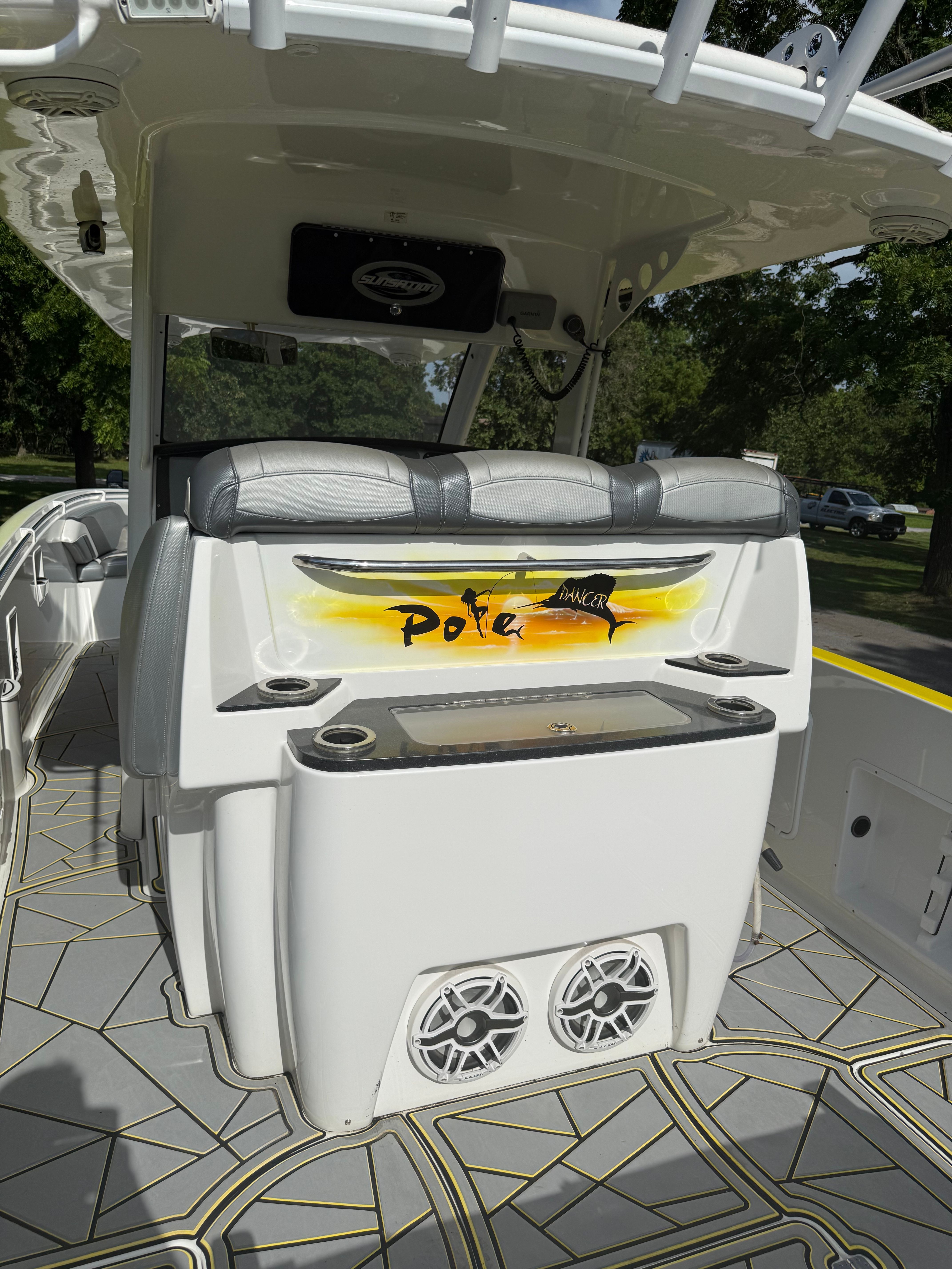 The image shows the cockpit of a 2014 Sunsation 34 CCX boat with modern seating and speakers.