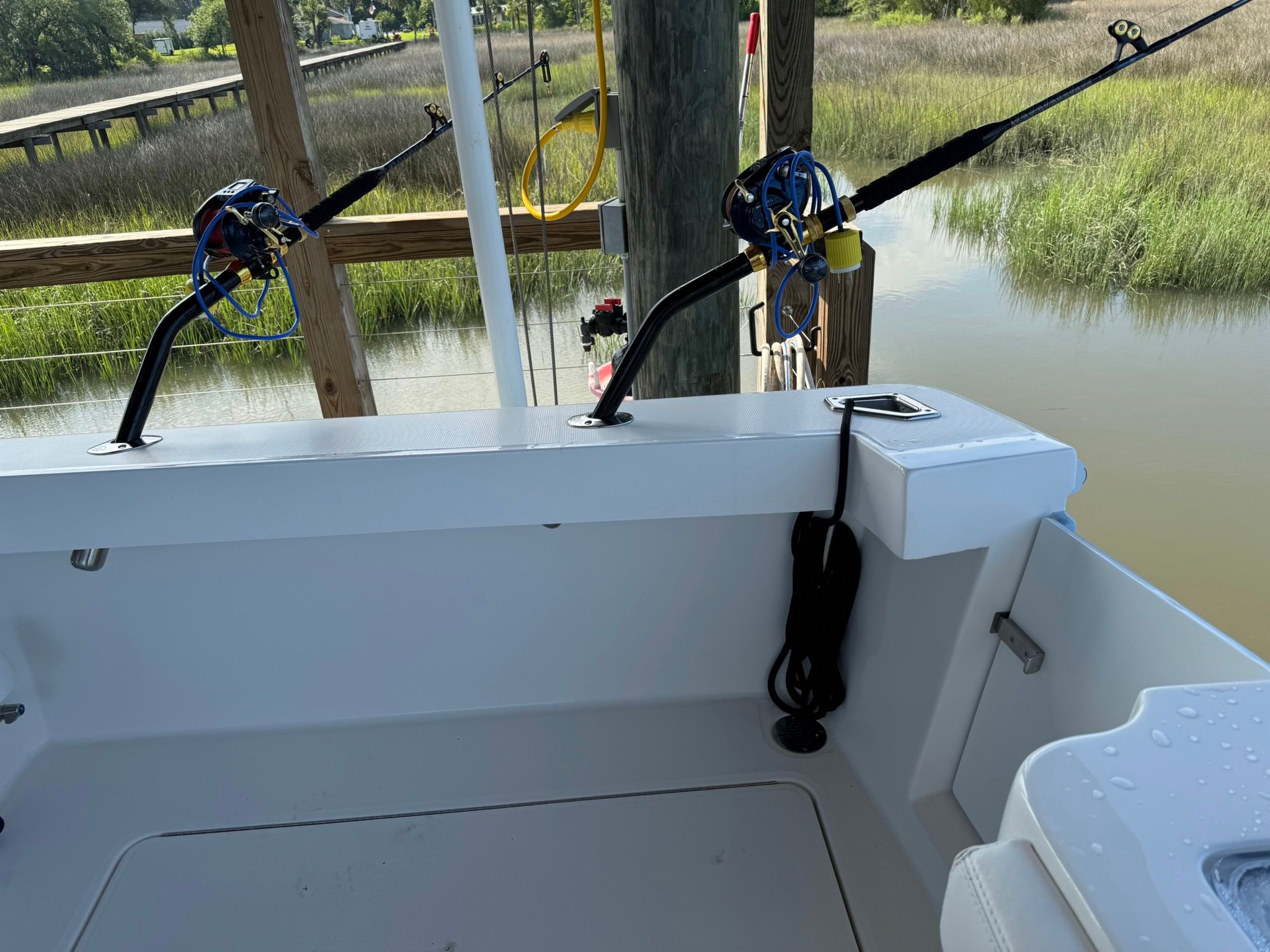 The image shows the stern of a 2024 Albemarle 30 Express boat with fishing rods.