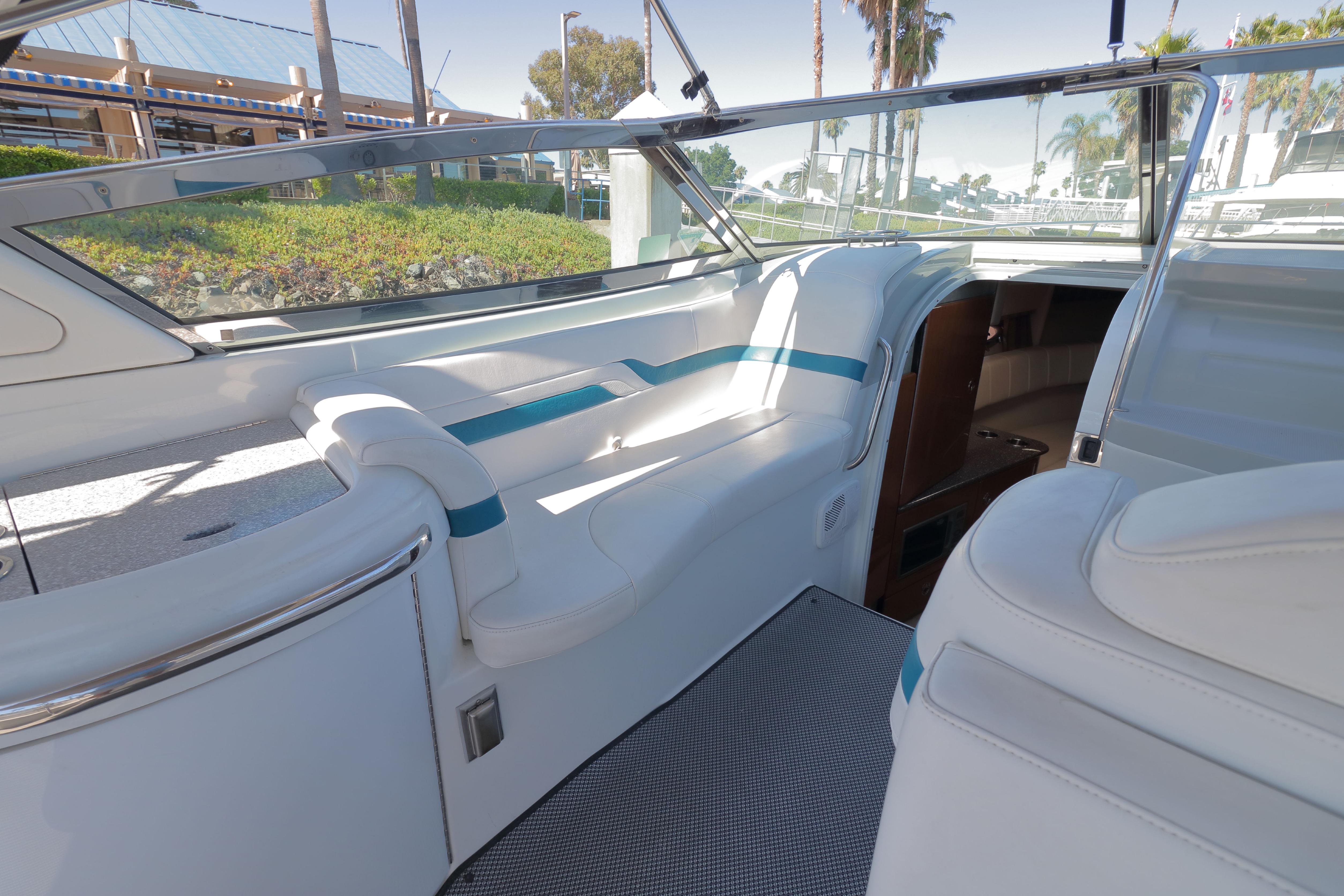 Interior of a 2006 Formula 330 Sun Sport boat with white seating and blue accents.