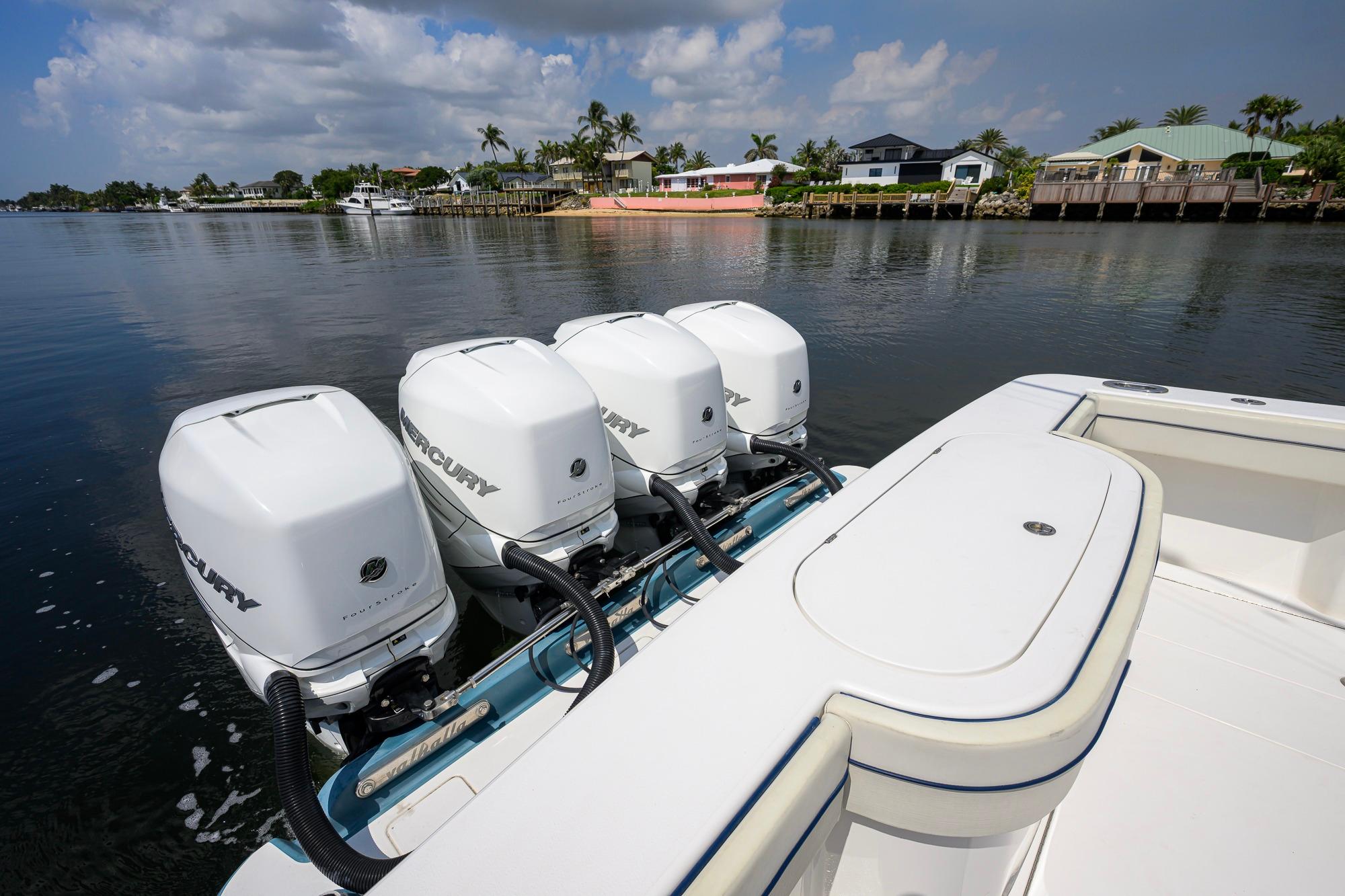 2020 Valhalla Boatworks V-41 with four Mercury outboard engines on a calm waterfront.