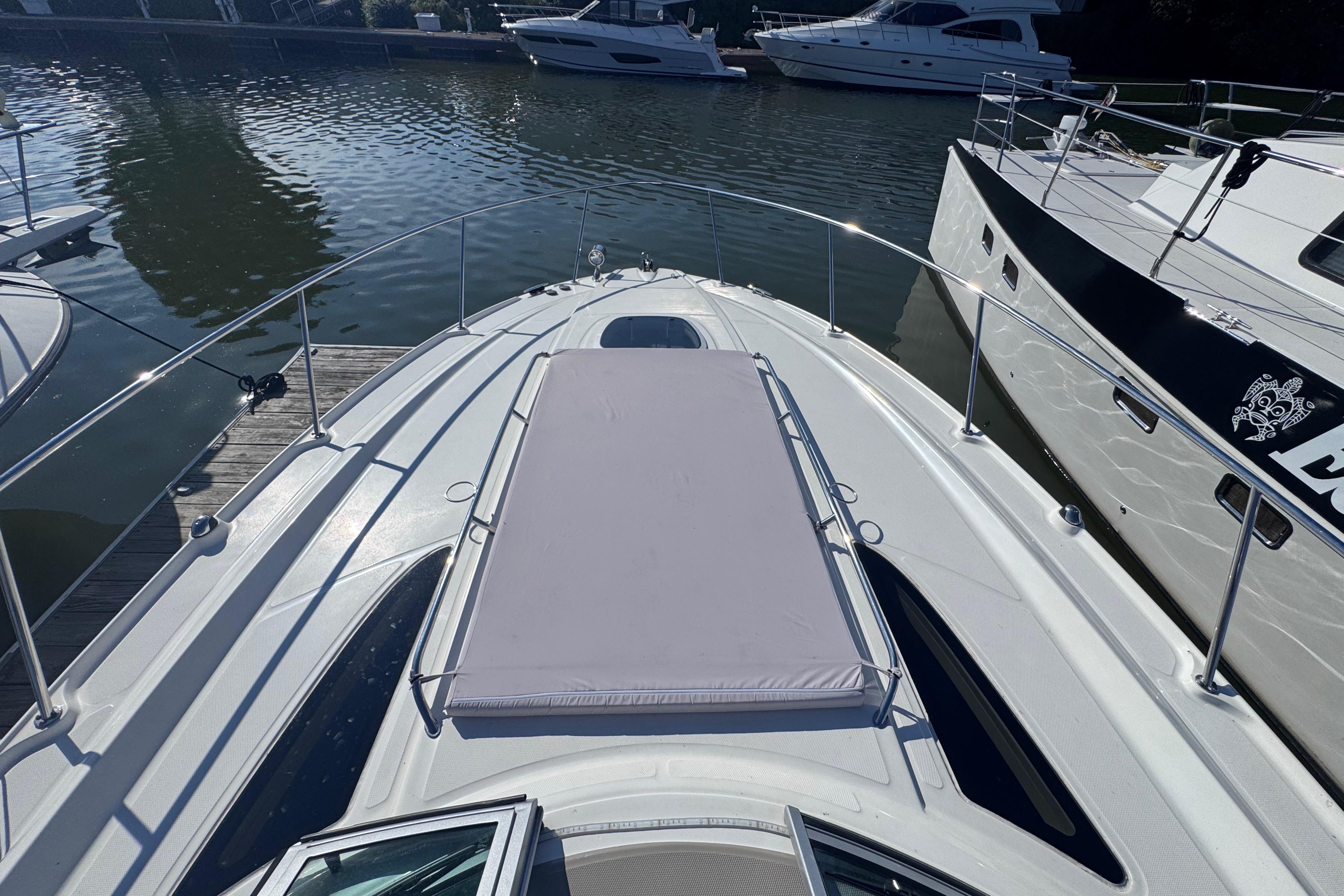 2008 Sea Ray 350 Sundancer yacht docked, featuring spacious sunbathing area on deck.