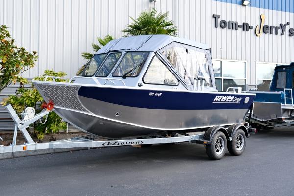 2024 Hewescraft 180 Pro-V ET boat on trailer outside dealership.