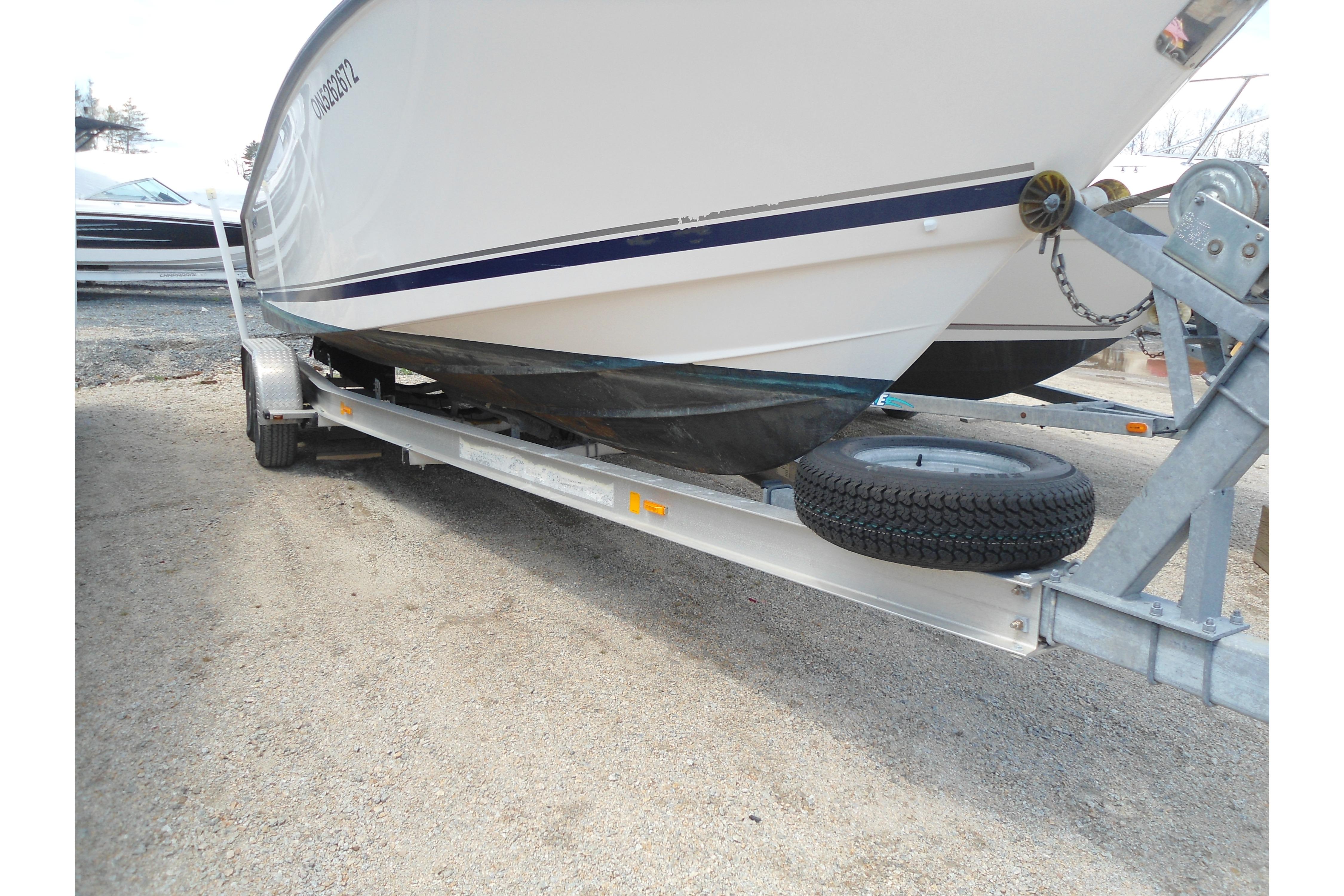 2013 Pursuit C 260 Center Console boat on trailer, side view.