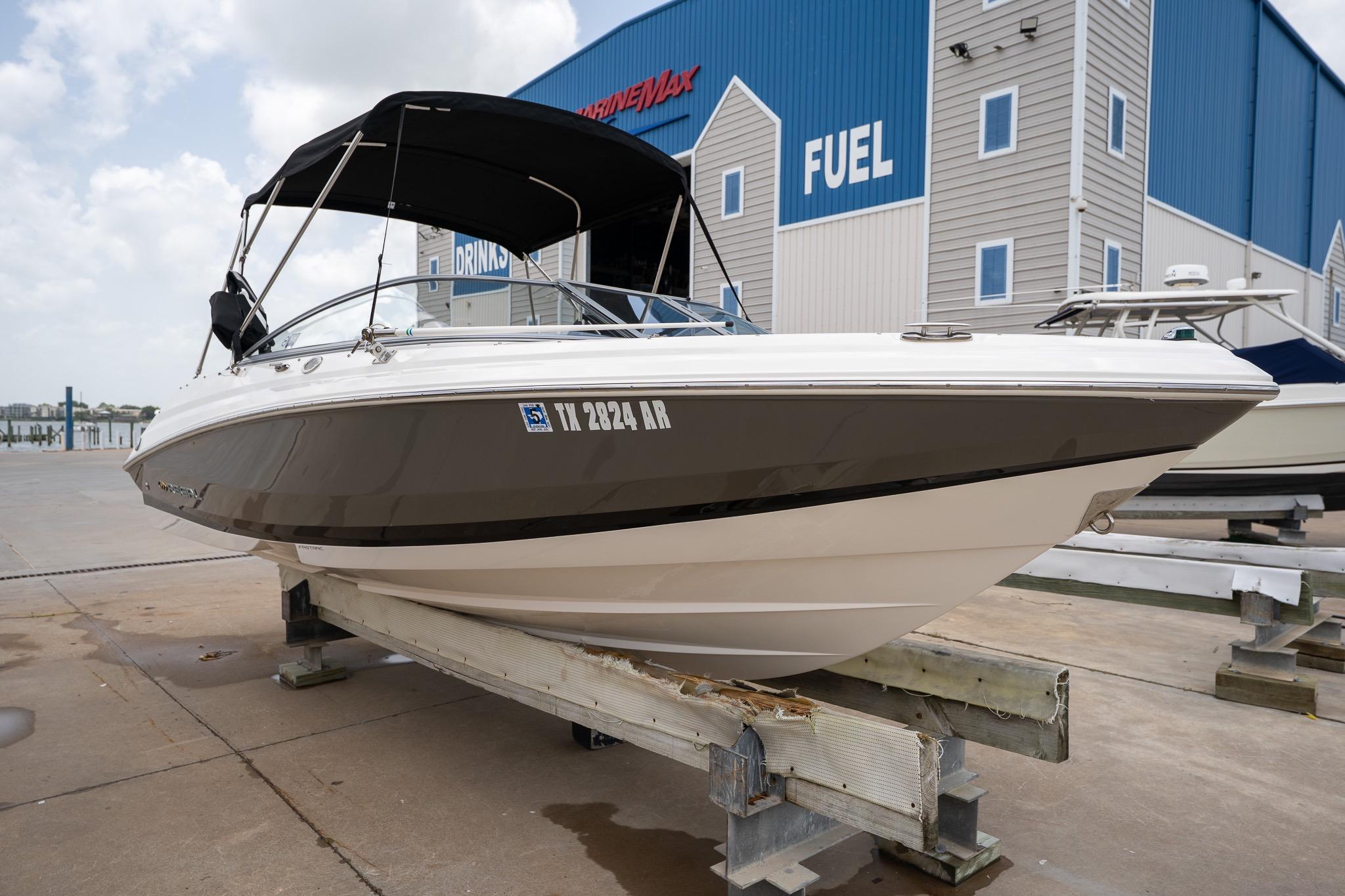 2008 Regal 2000 Bowrider boat on dock, near blue fuel station building.