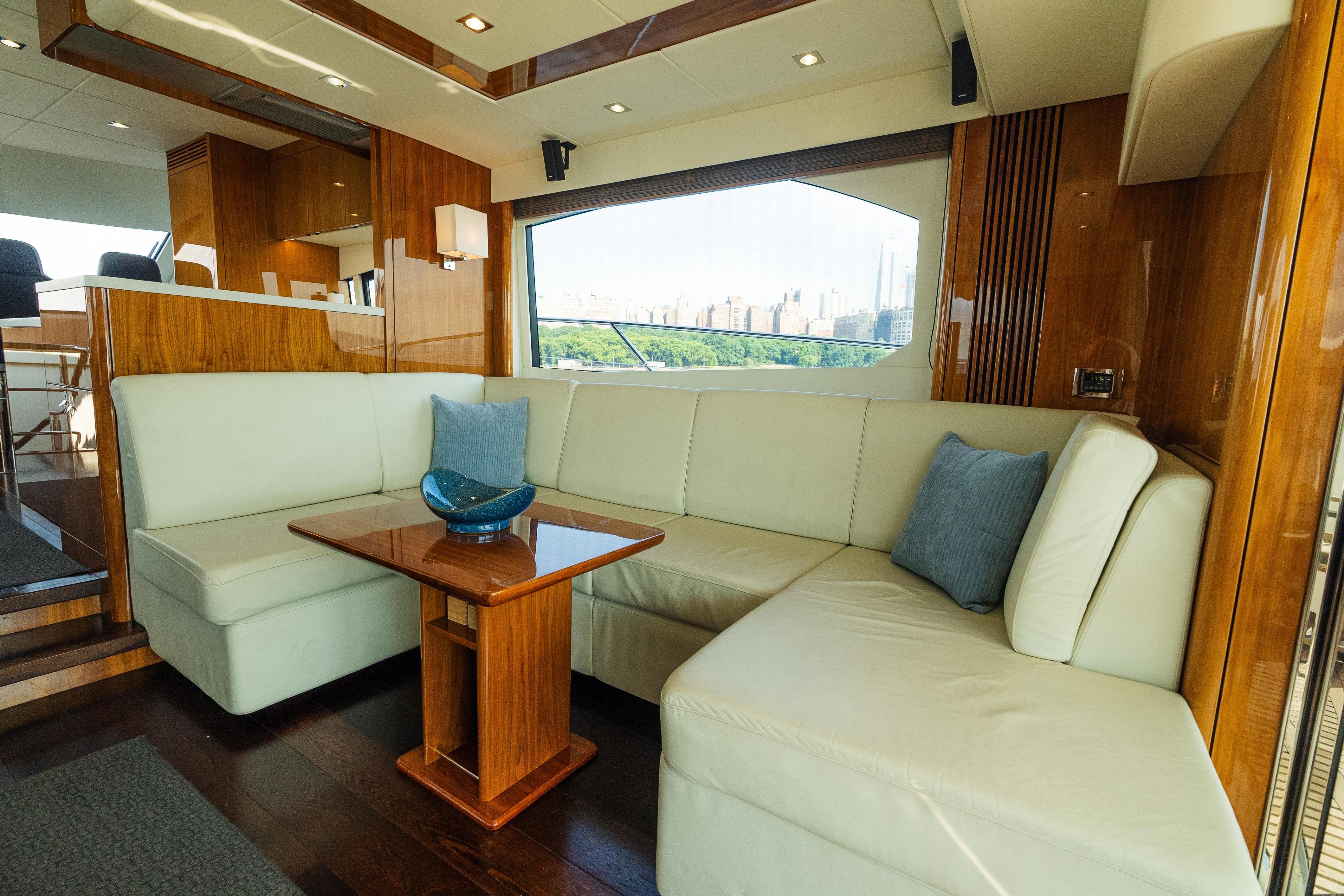 Luxurious interior of 2016 Sunseeker Manhattan 65 yacht with elegant seating and wooden accents.