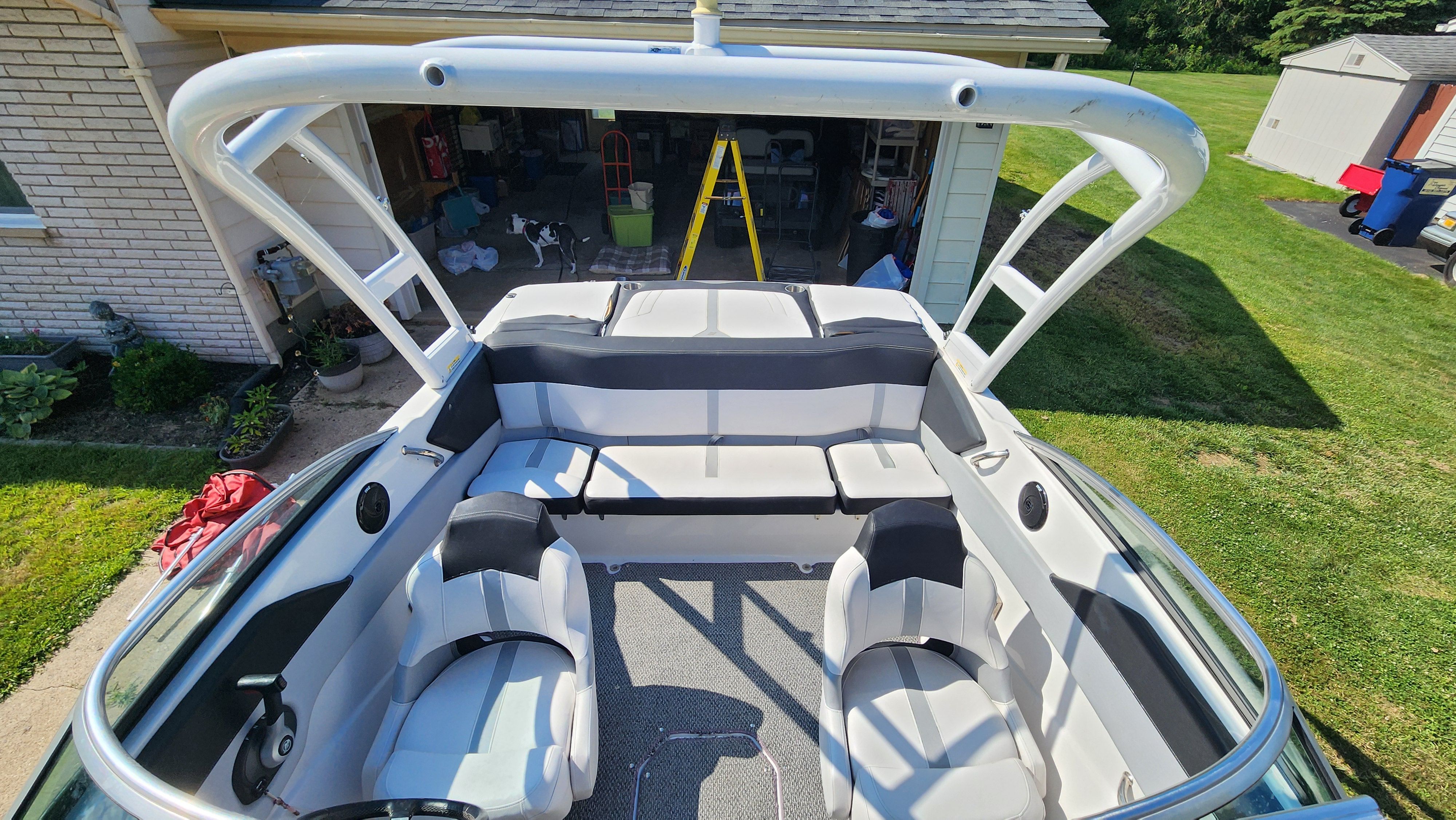 The image shows the cockpit of a 2015 Four Winns H190 boat with white and gray seating.
