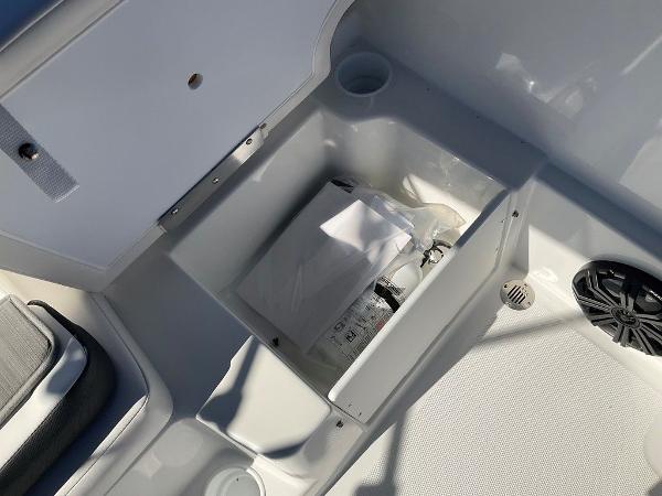 2025 Tahoe T18 boat storage compartment with safety equipment and speaker.