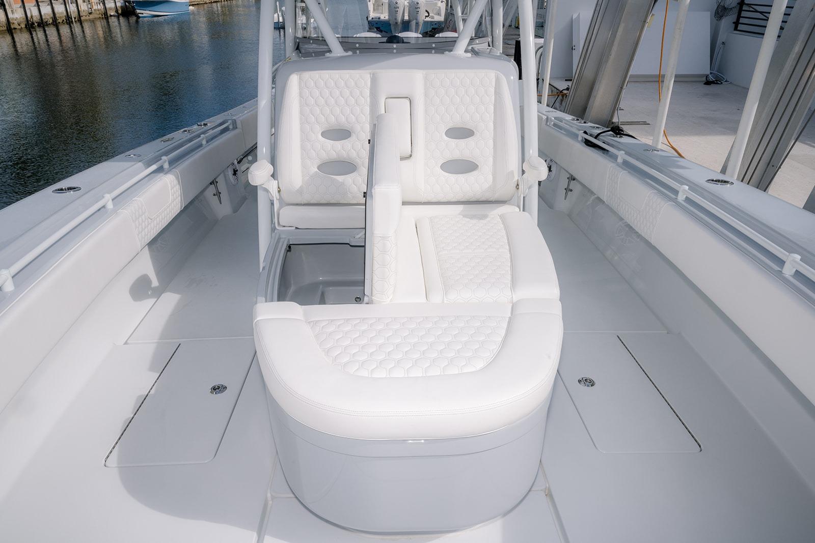 2024 Contender 44 ST boat interior with white cushioned seating and sleek design.