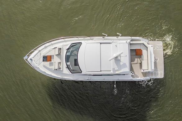 2023 Cruisers Yachts 42 Cantius, aerial view, cruising on water.