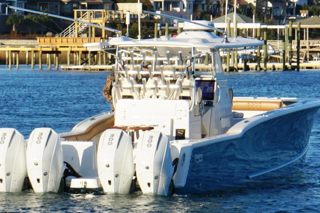 2022 Tideline 365 Offshore boat with multiple engines on a calm waterway.