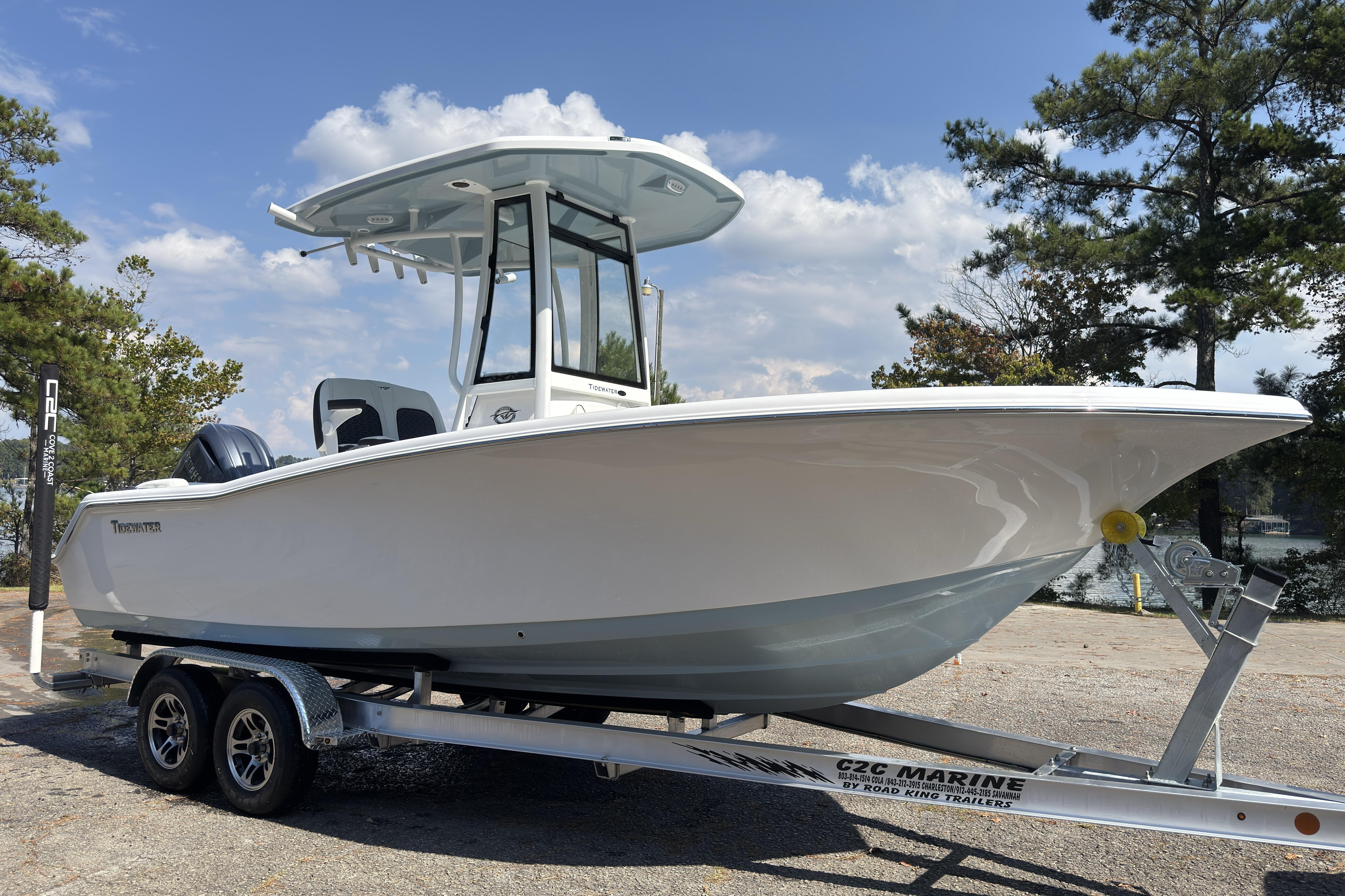 2026 Tidewater 220 LXF boat on trailer, parked outdoors under a clear sky.