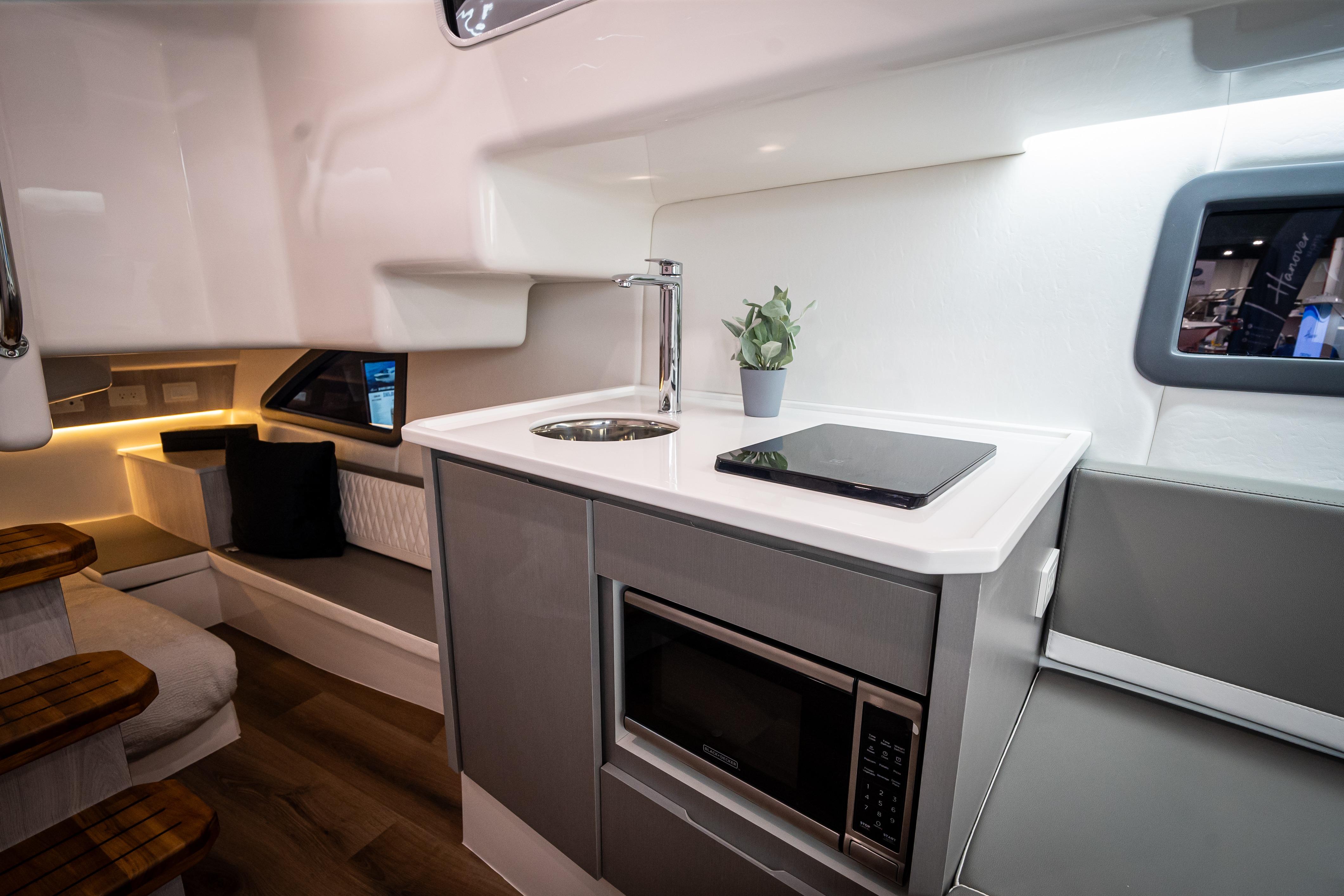 Modern kitchen interior of Hanover 347 yacht, featuring sleek design and compact appliances, 2026 model.