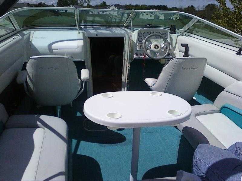 Interior of a 1993 Chris-Craft 238 Cuddy Concept with blue carpet and white upholstery.