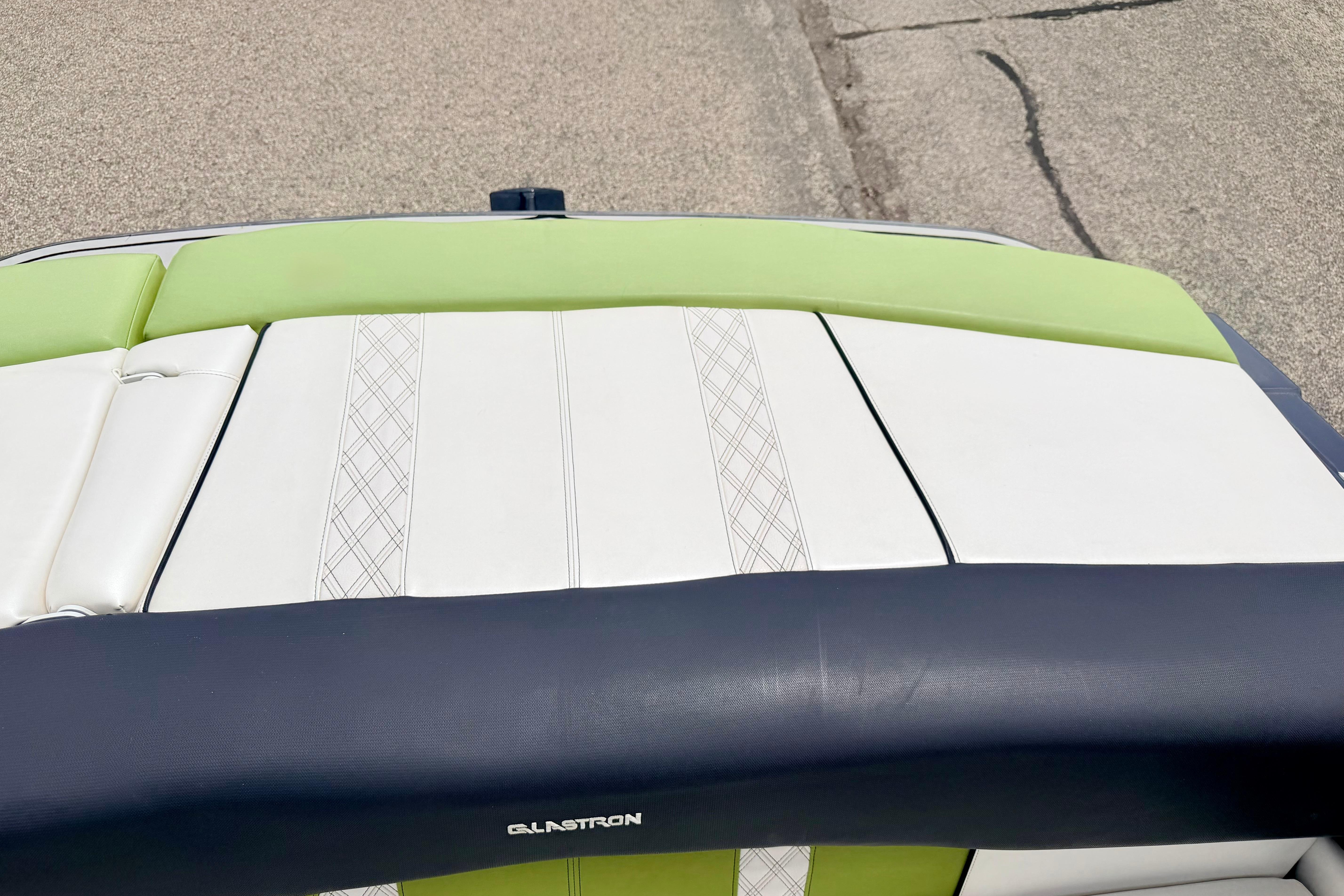 2018 Glastron GT 185 boat seat with green and white upholstery design.
