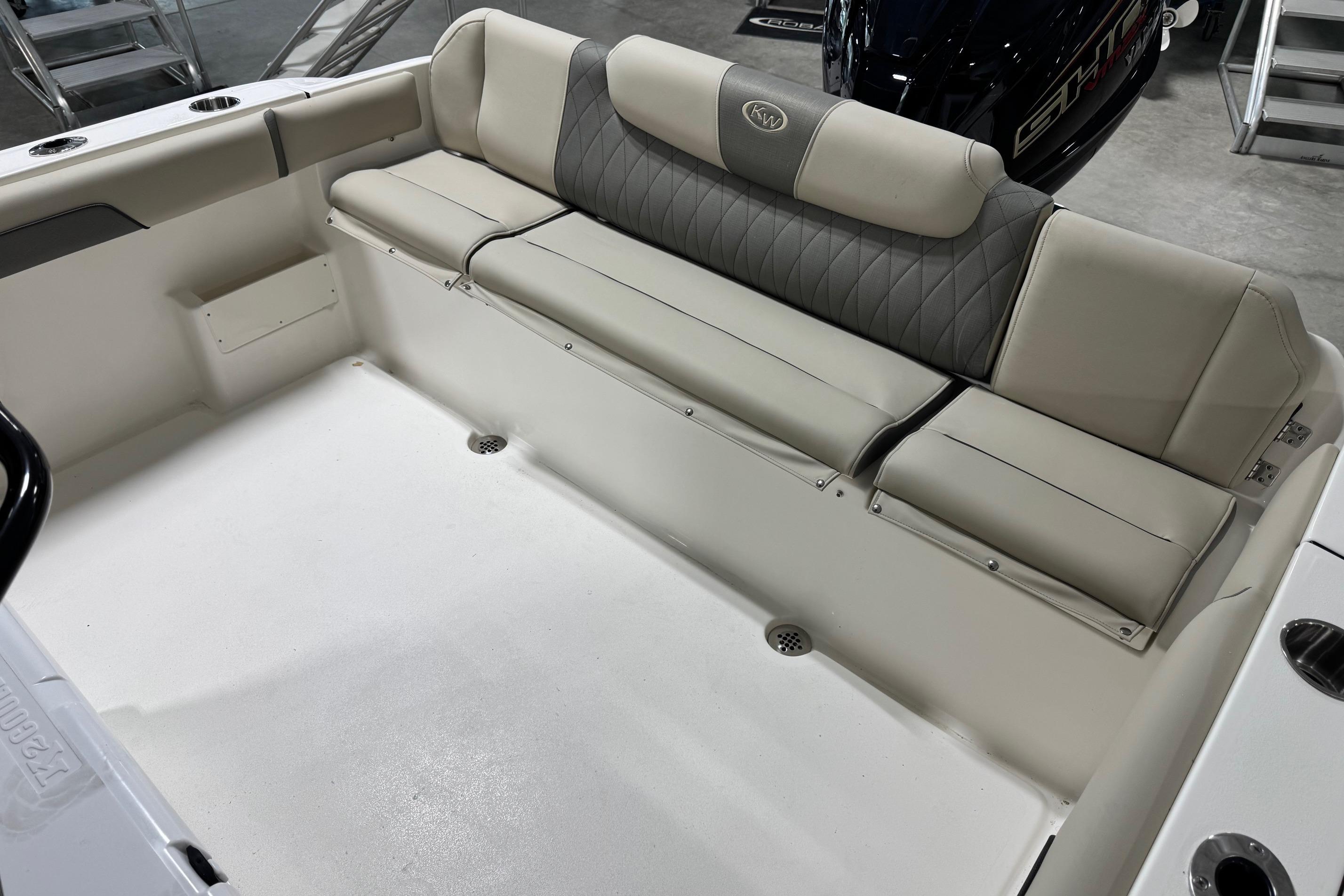 2026 Key West 239 FS boat interior with cushioned seating and storage.