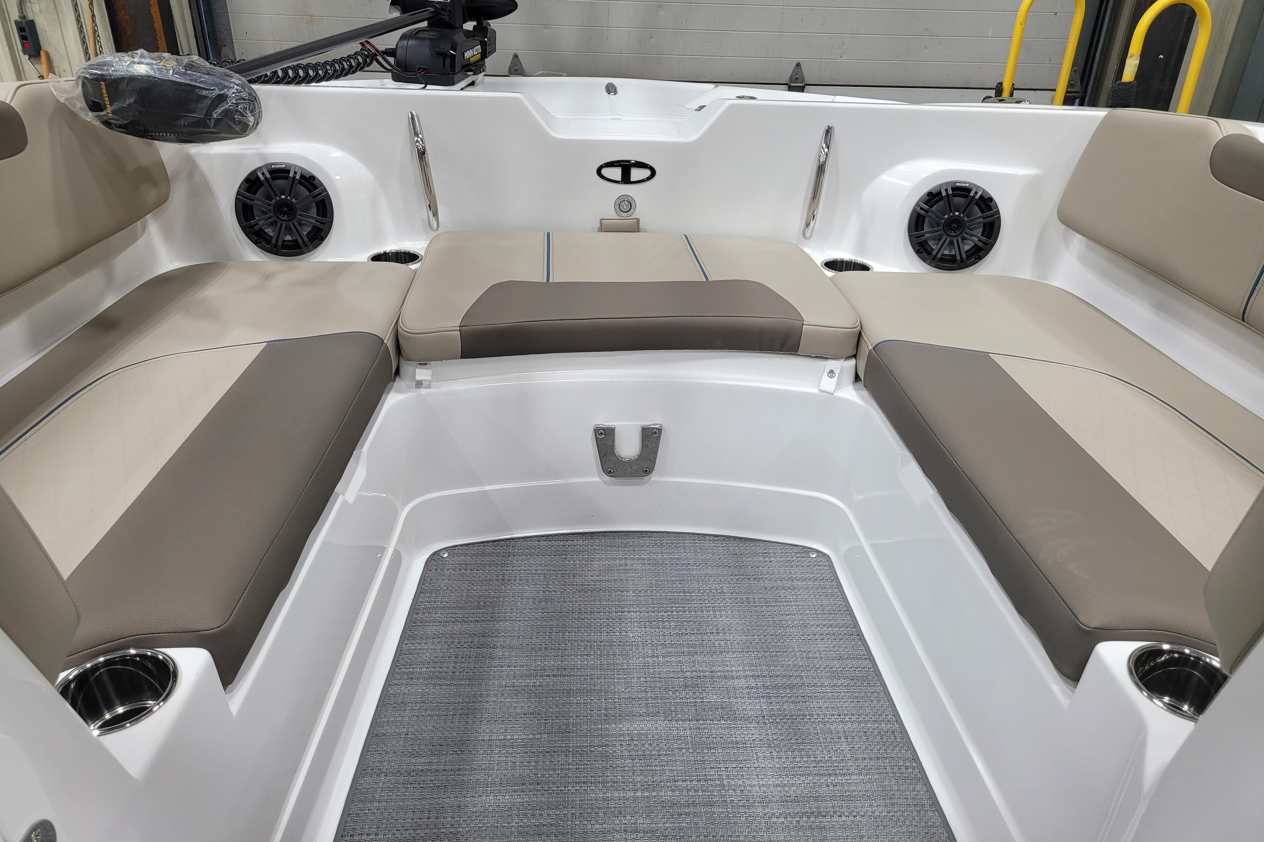 2026 Tahoe 2150 boat interior with beige seating and integrated speakers.
