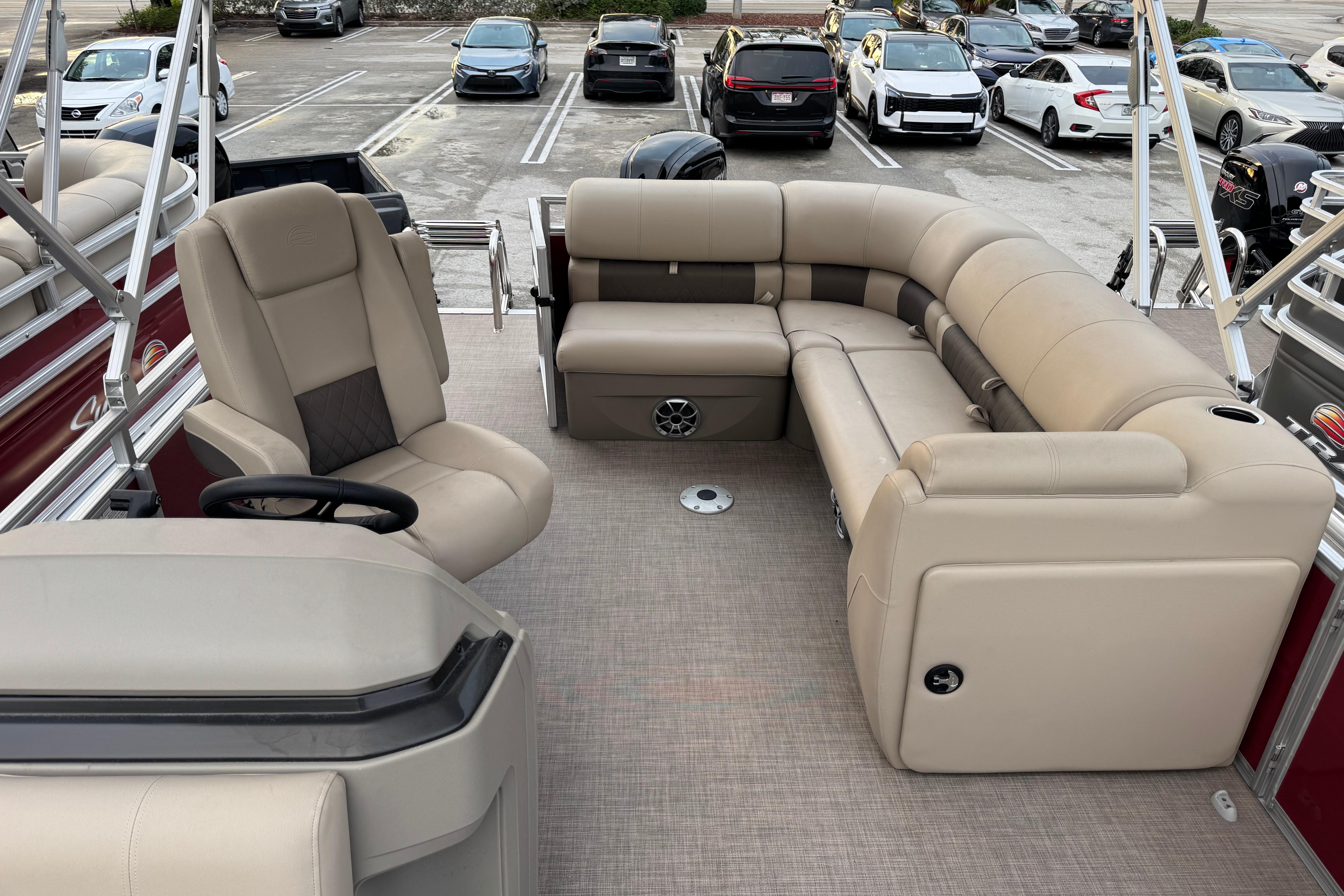 2025 Sun Tracker Party Barge 20 DLX with beige seating and spacious deck layout.