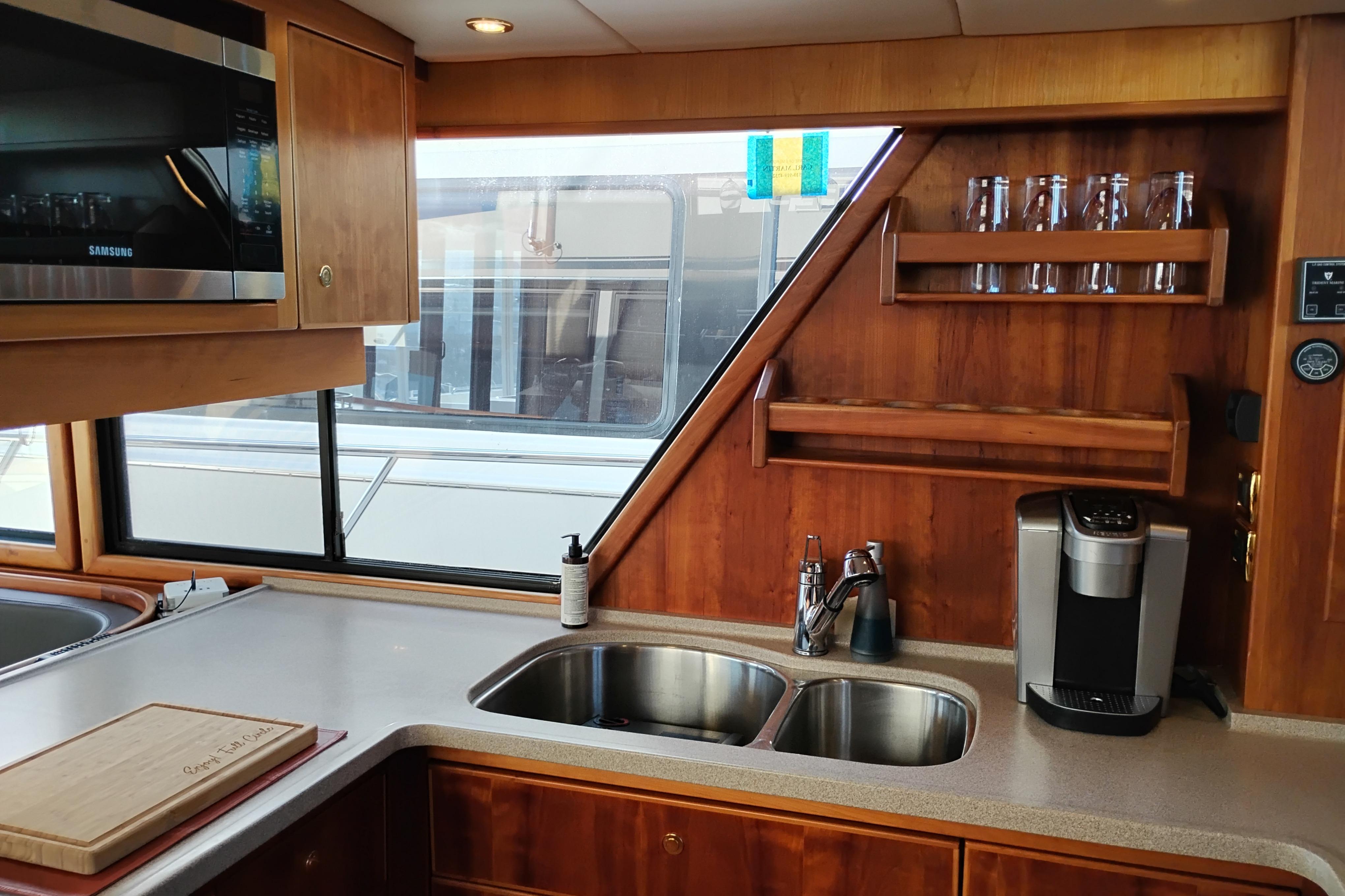 Interior of 2002 Canoe Cove 50 Pilothouse Motor Yacht kitchen with sink and appliances.